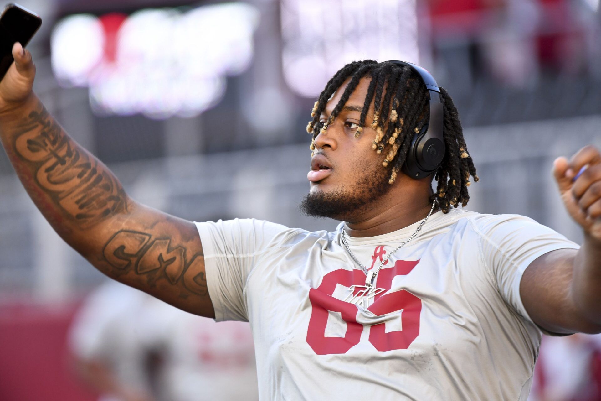 Nov 4, 2023; Tuscaloosa, Alabama, USA; Alabama Crimson Tide offensive lineman JC Latham (65) stretches on the field before a game against the LSU Tigers at Bryant-Denny Stadium. Mandatory Credit: Gary Cosby Jr.-USA TODAY Sports