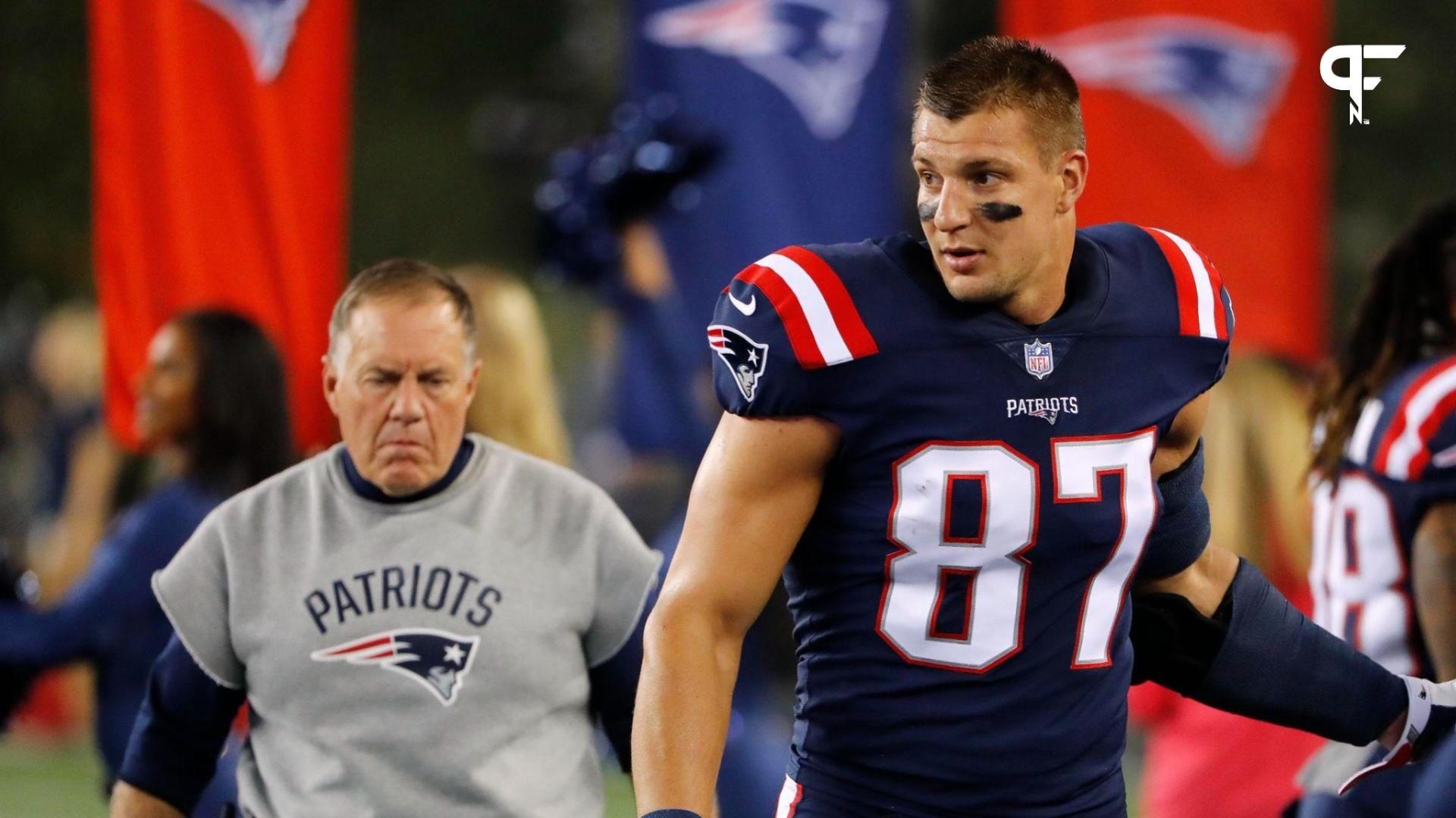 New England Patriots tight end Rob Gronkowski (87) and Patriots head coach Bill Belichick walk along the sidelines before their game against the Houston Texans at Gillette Stadium.