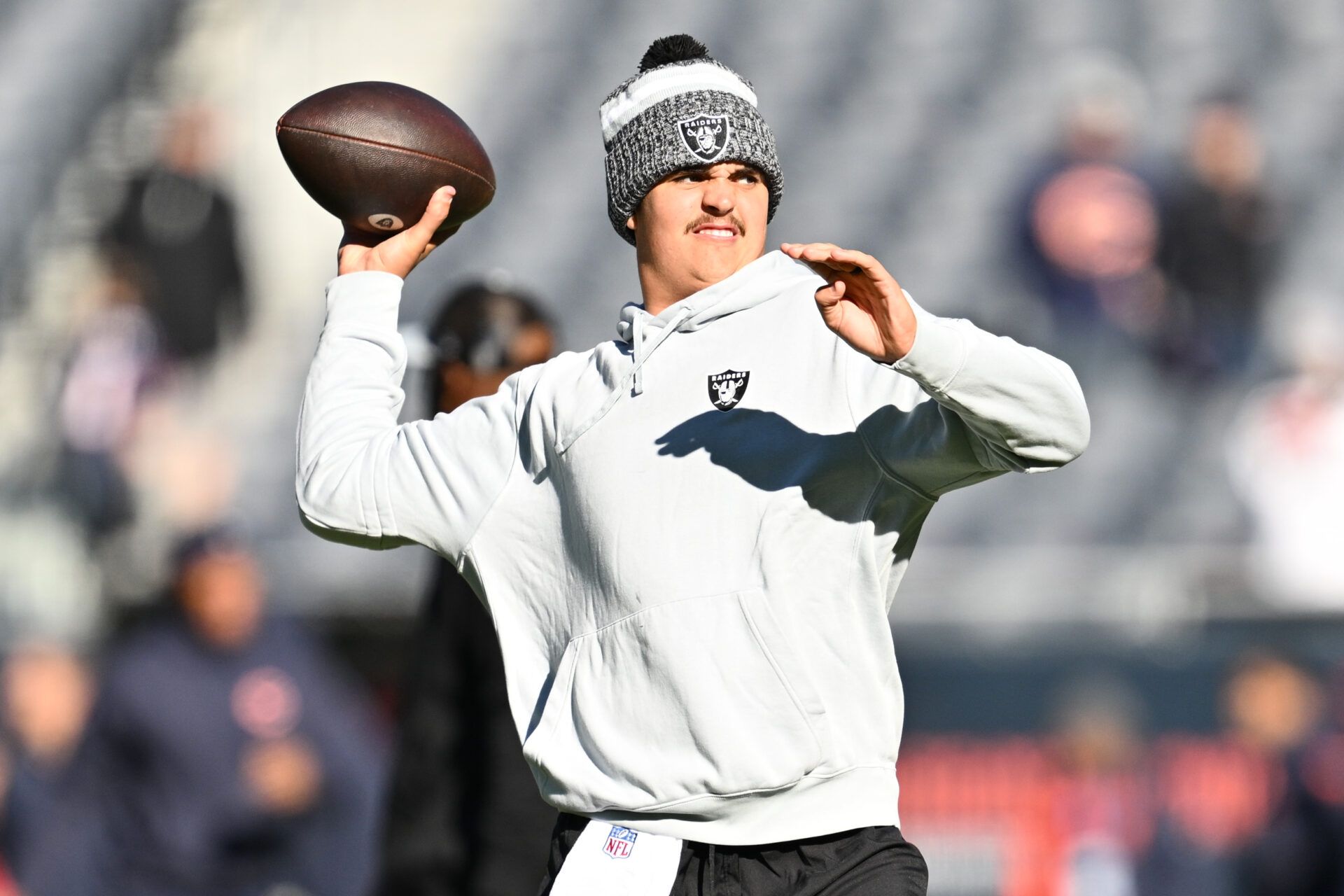 Las Vegas Raiders quarterback Aidan O'Connell (4) warms up before a game against the Chicago Bears at Soldier Field.