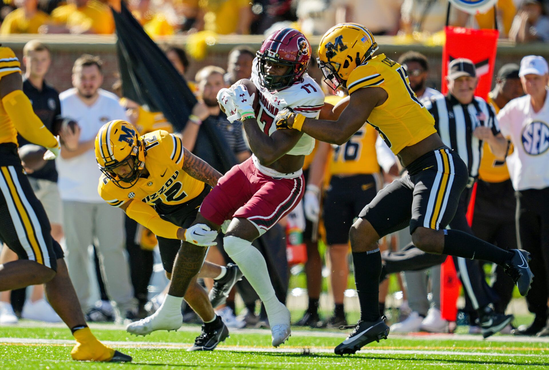 South Carolina Gamecocks wide receiver Xavier Legette (17) is tackled by Missouri Tigers defensive back Dreyden Norwood (12) and defensive back Daylan Carnell (13) during the first half at Faurot Field at Memorial Stadium.