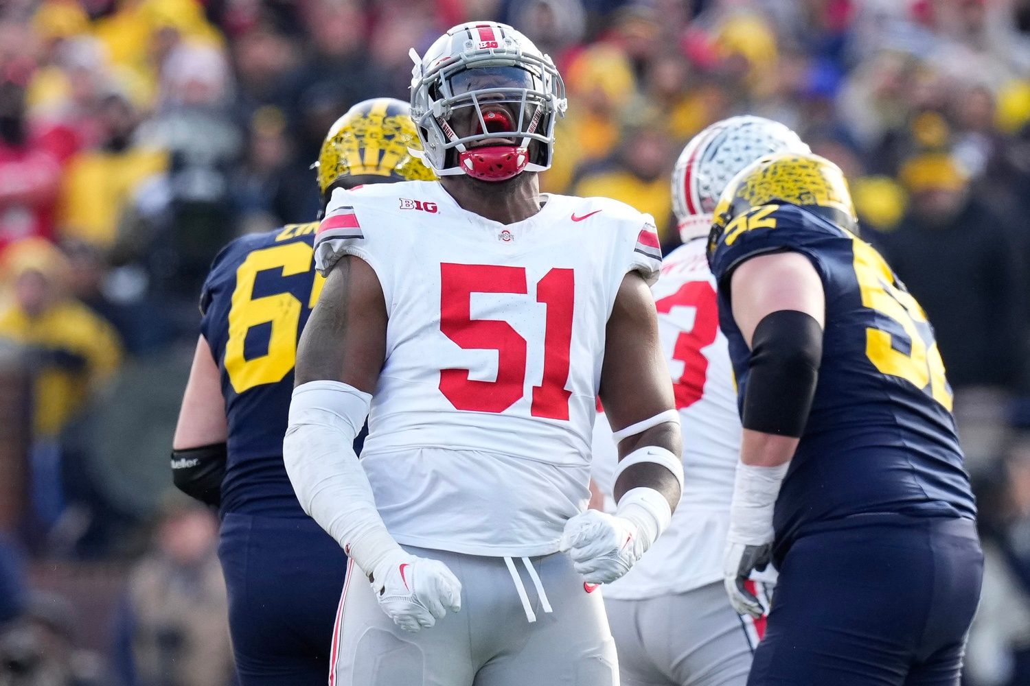 Ohio State Buckeyes defensive tackle Michael Hall Jr. (51) celebrates a sack of Michigan Wolverines quarterback J.J. McCarthy (9) during the first half of the NCAA football game at Michigan Stadium.