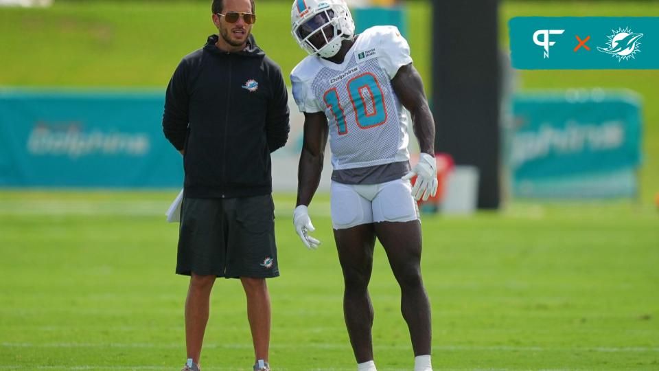 Miami Dolphins head coach Mike McDaniel talks with Miami Dolphins wide receiver Tyreek Hill (10) during practice at Baptist Health Training Complex.