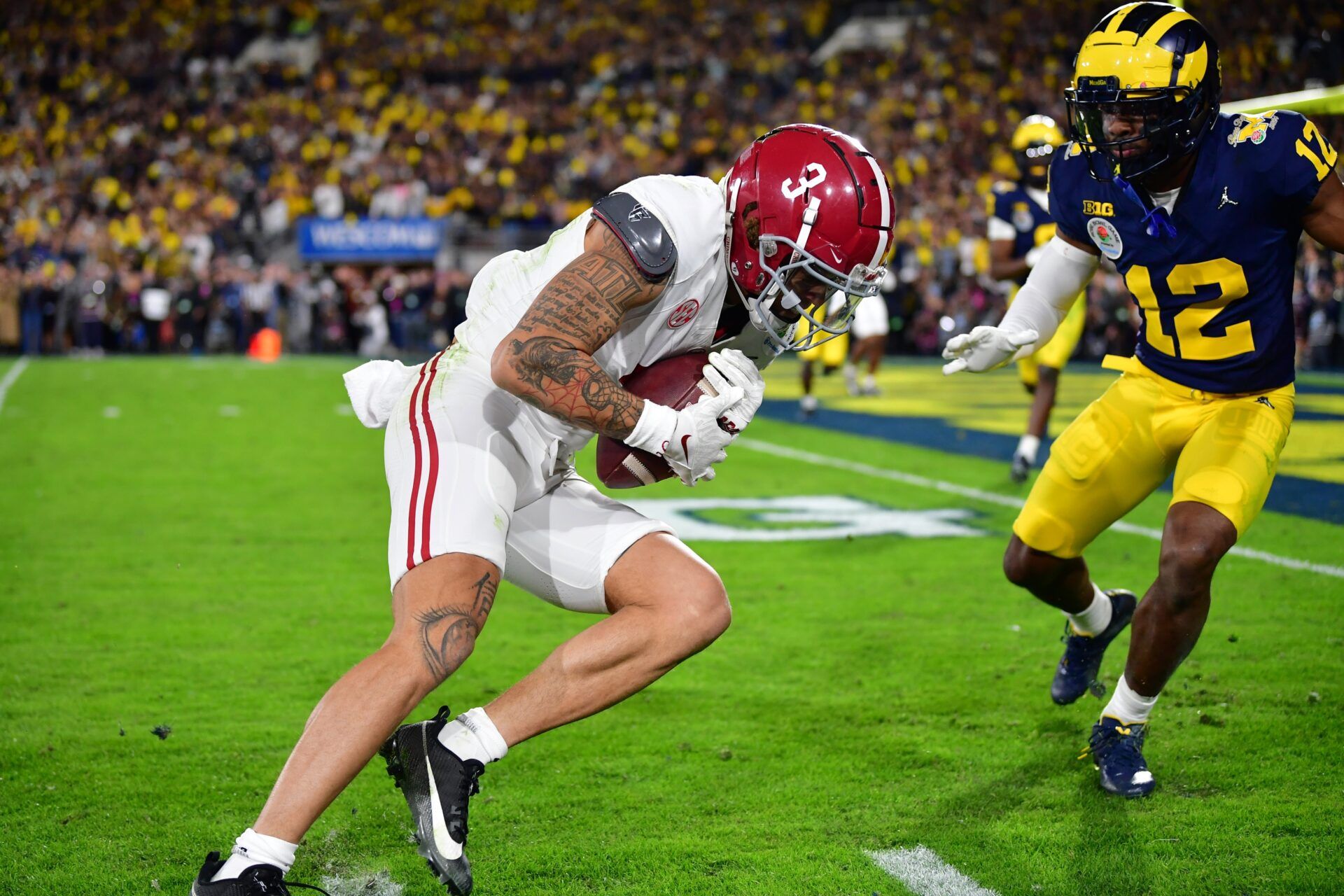 Alabama Crimson Tide wide receiver Jermaine Burton (3) makes a catch against Michigan Wolverines defensive back Josh Wallace (12) in overtime in the 2024 Rose Bowl college football playoff semifinal game at Rose Bowl.