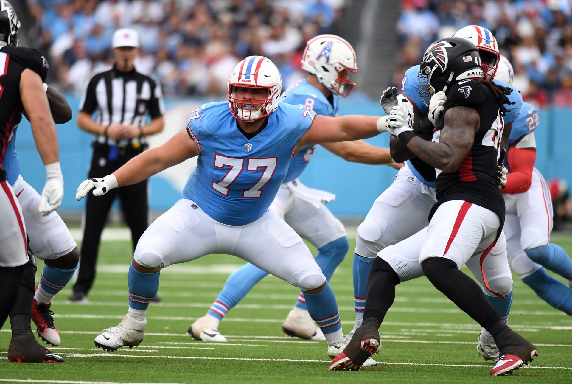 Tennessee Titans offensive tackle Peter Skoronski (77) blocks during the first half against the Atlanta Falcons at Nissan Stadium.