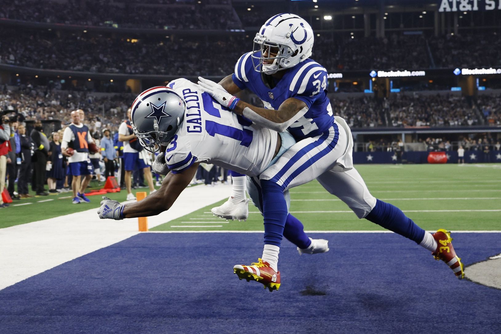 Dallas Cowboys wide receiver Michael Gallup (13) catches a touchdown pass against Indianapolis Colts cornerback Isaiah Rodgers (34) in the fourth quarter at AT&T Stadium.