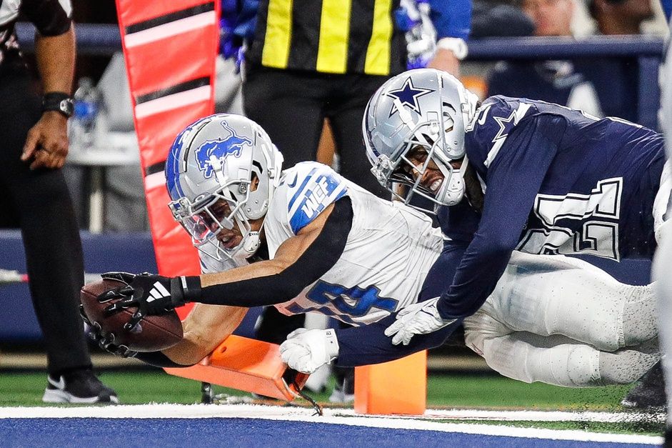 Detroit Lions WR Amon-Ra St. Brown (14) dives in for a touchdown against the Dallas Cowboys.