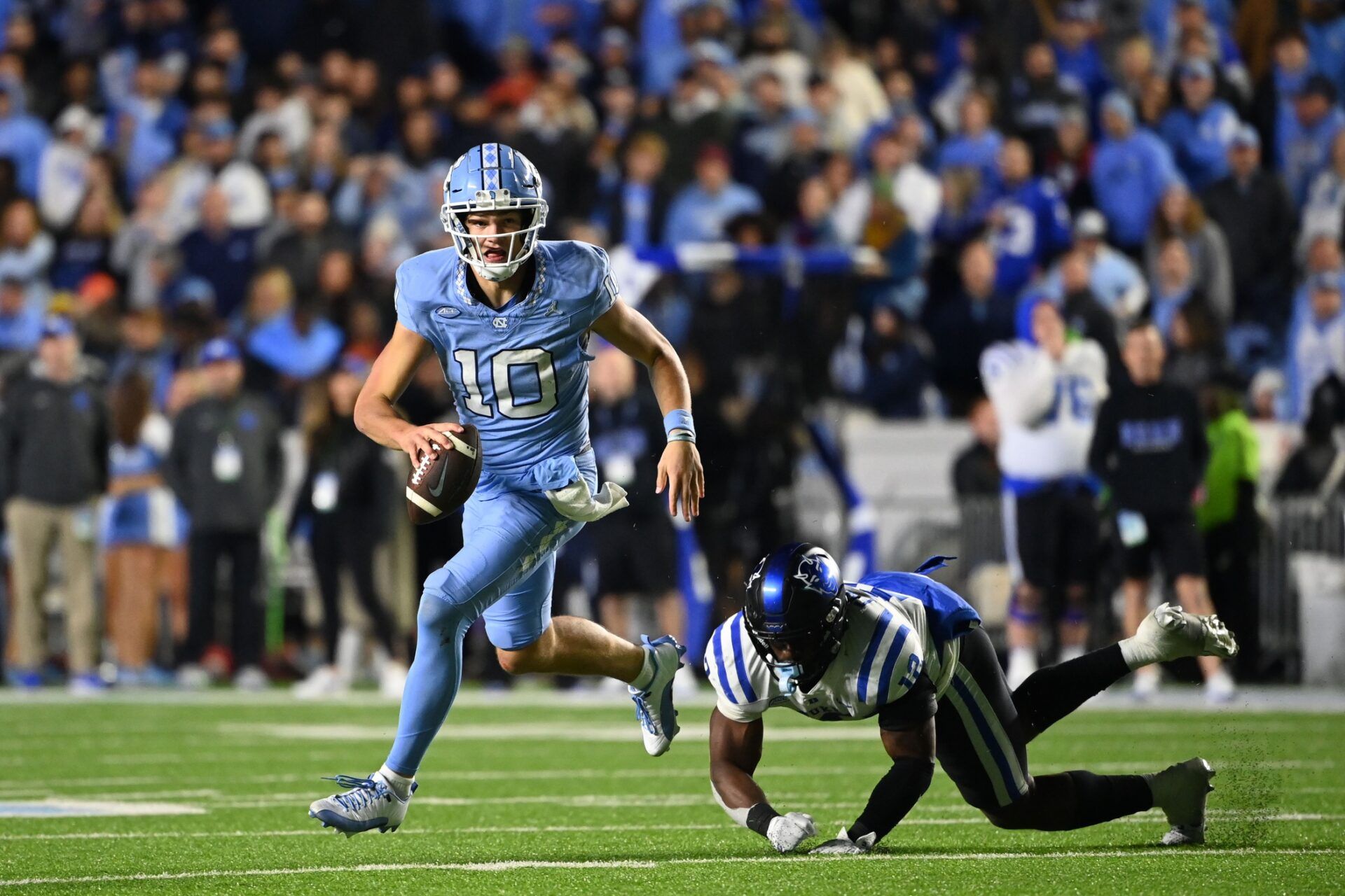 North Carolina Tar Heels quarterback Drake Maye (10) looks to pass as Duke Blue Devils linebacker Tre Freeman (12) defends in the first overtime at Kenan Memorial Stadium. Mandatory Credit: Bob Donnan-USA TODAY Sports