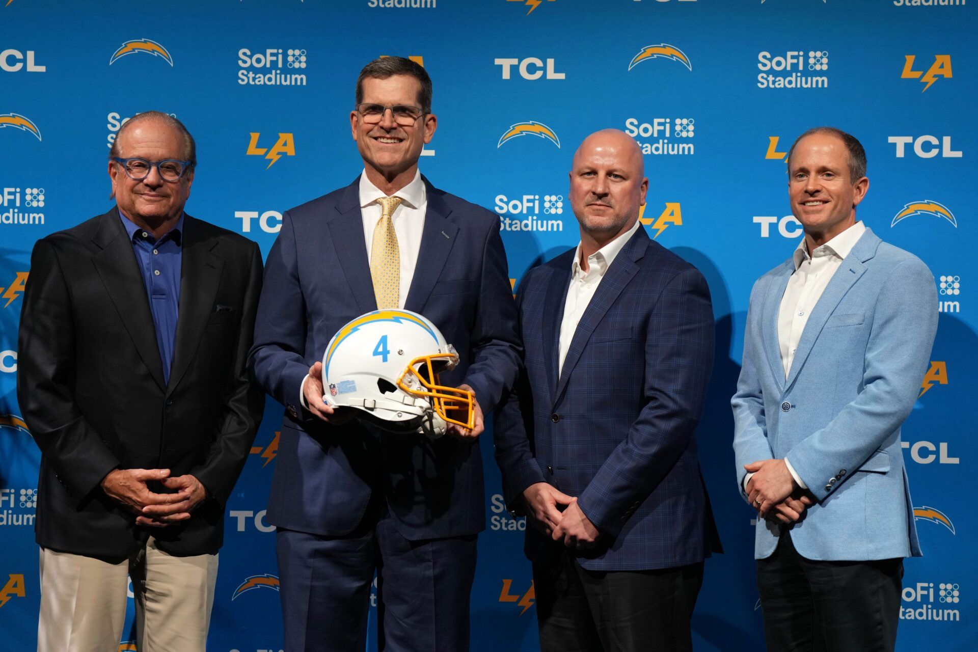 Los Angeles Chargers coach Jim Harbaugh (second from right) poses at an introductory press conference at YouTube Theater at SoFi Stadium.