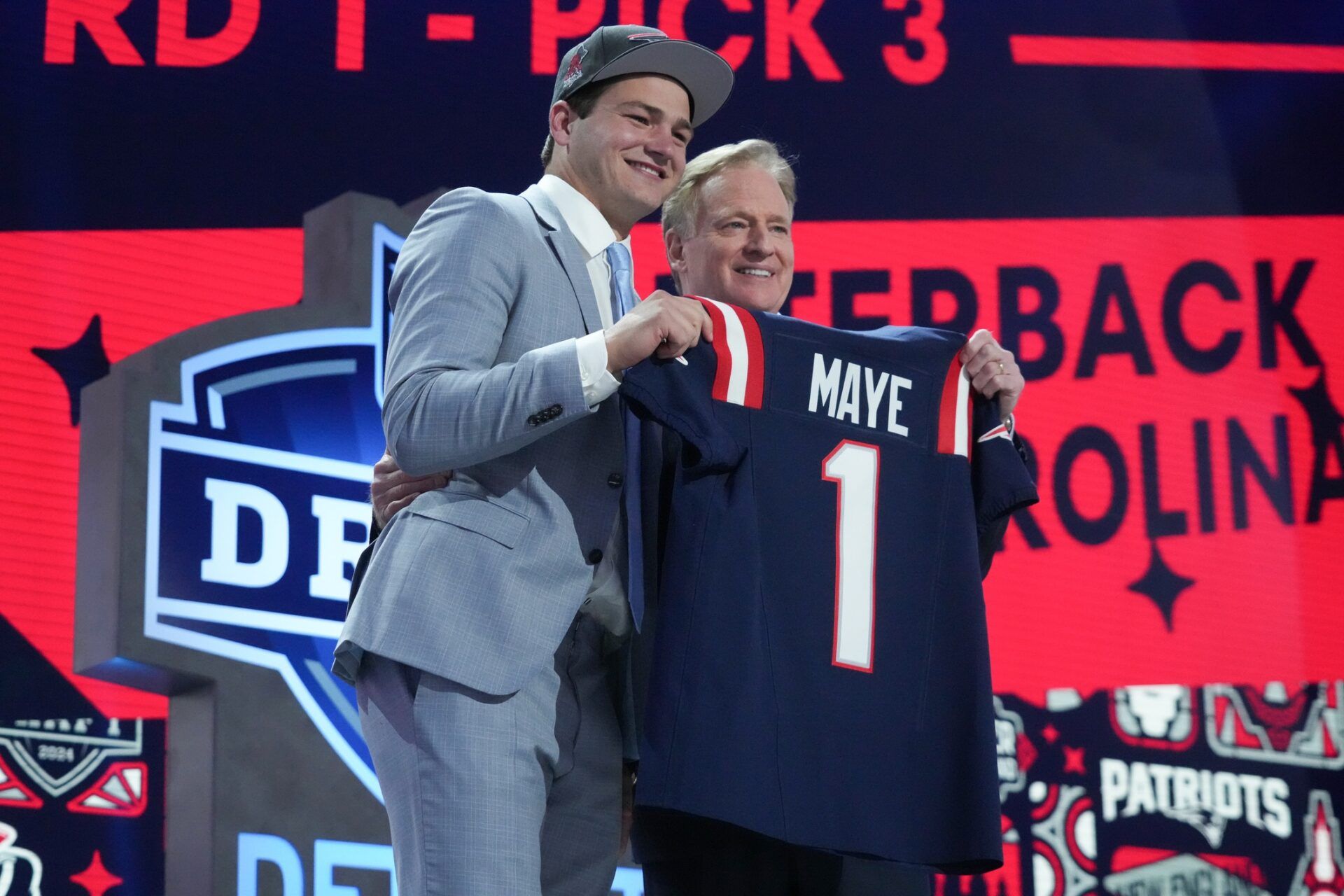 New England Patriots QB Drake Maye and NFL Commissioner Roger Goodell pose for pictures at the 2024 NFL Draft.