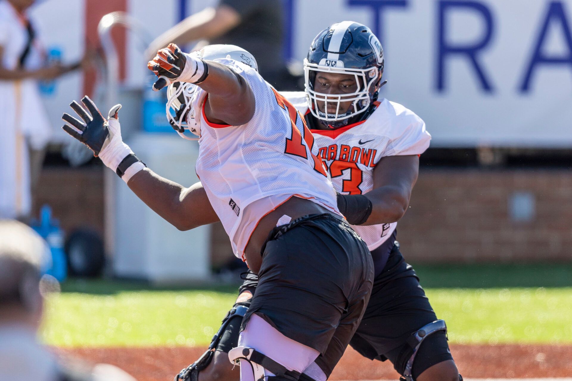 American offensive lineman Christian Haynes of Uconn (63) faces off against American offensive lineman Christian Jones of Texas (70) during practice for the American team at Hancock Whitney Stadium.