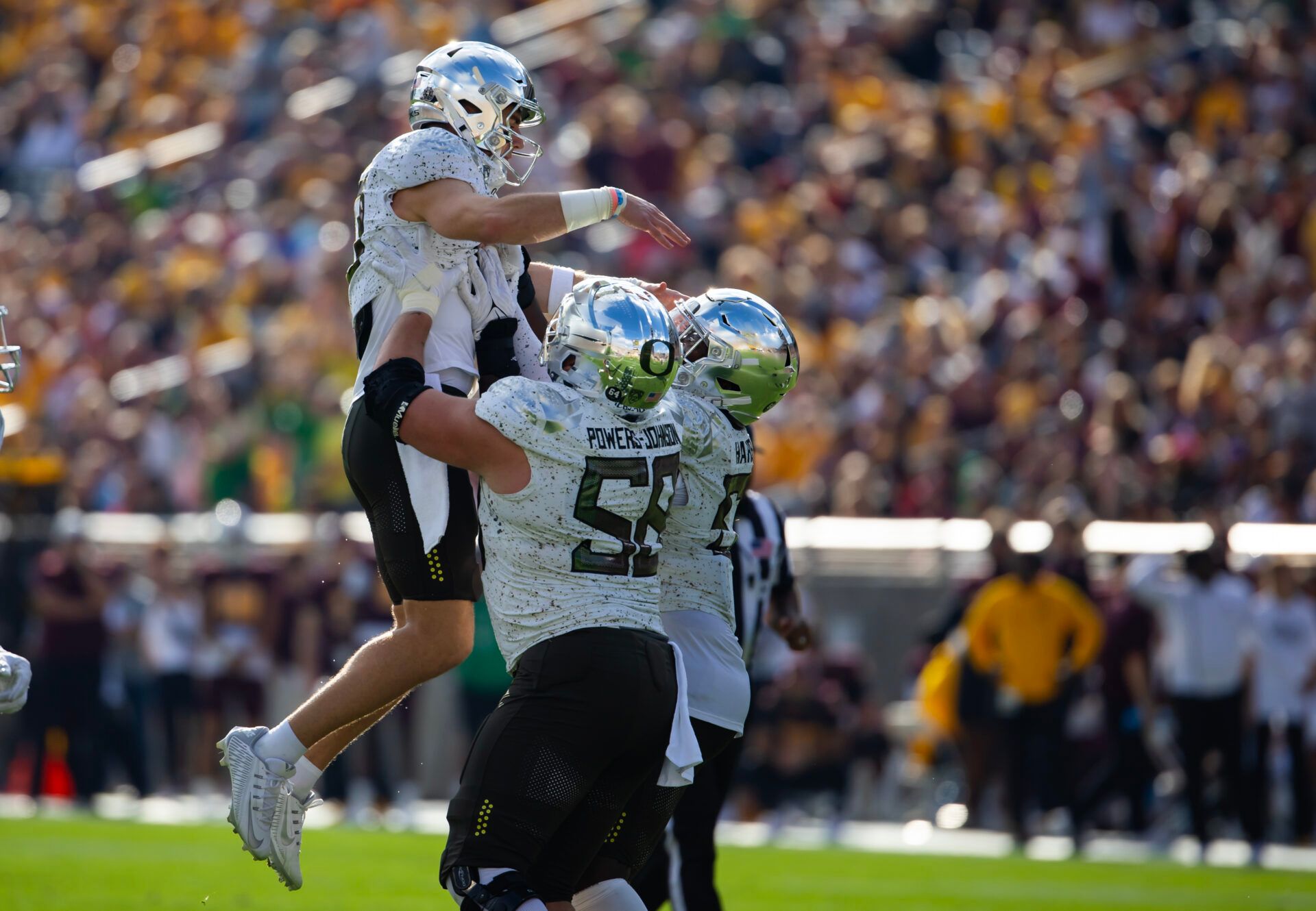 Oregon Ducks quarterback Bo Nix (10) is hoisted in the air as he celebrates a touchdown with offensive lineman Jackson Powers-Johnson (58) against the Arizona State Sun Devils in the first half at Mountain America Stadium.