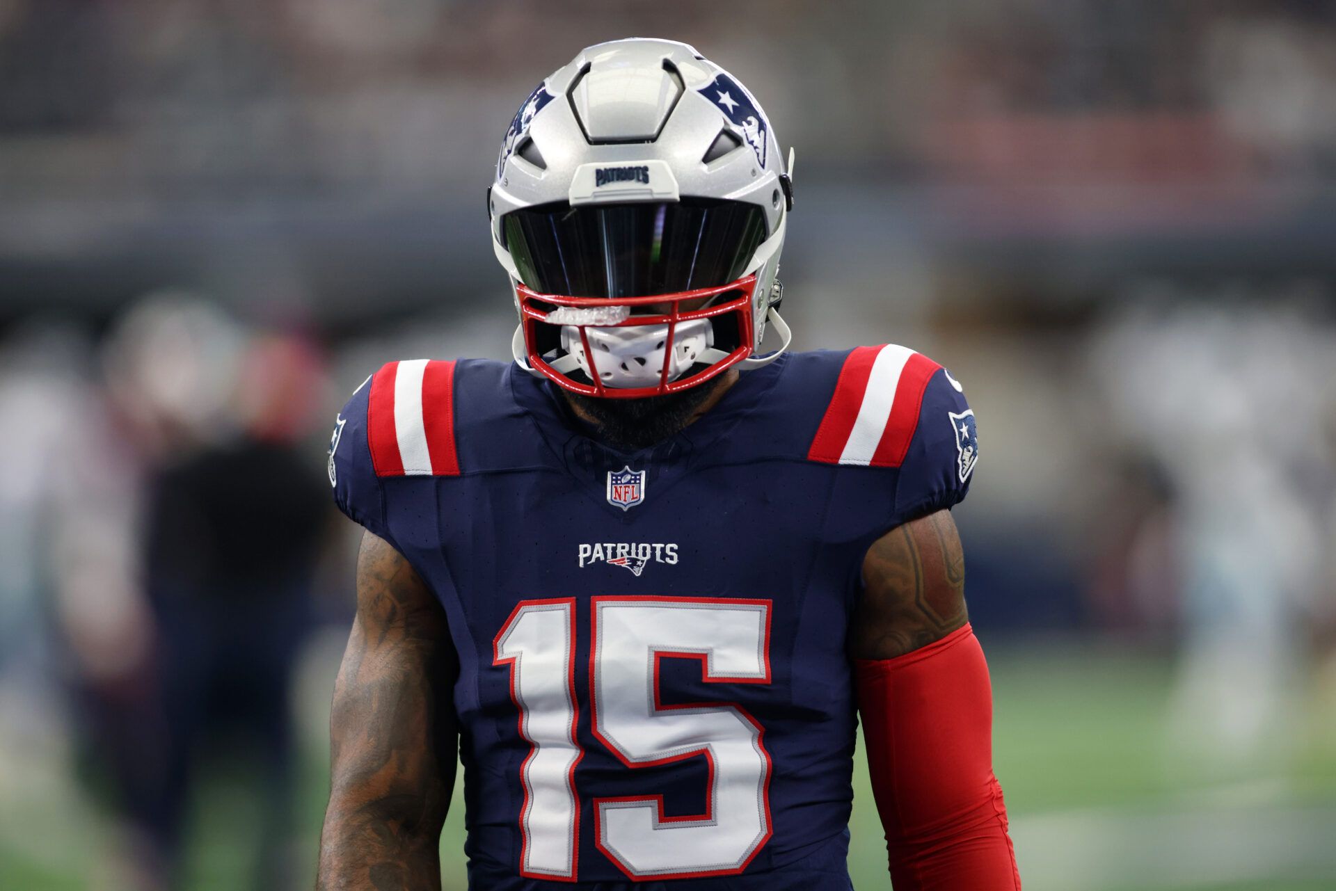 New England Patriots running back Ezekiel Elliott (15) walks on the field before the game against the Dallas Cowboys at AT&T Stadium.