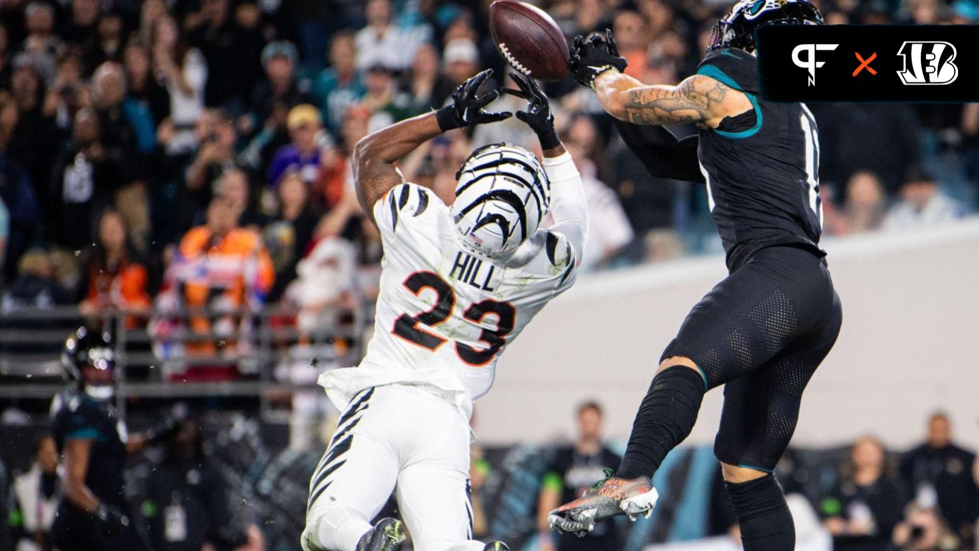 Jacksonville Jaguars wide receiver Parker Washington (11) makes the catch for a touchdown against Cincinnati Bengals safety Dax Hill (23) in the third quarter at EverBank Stadium.