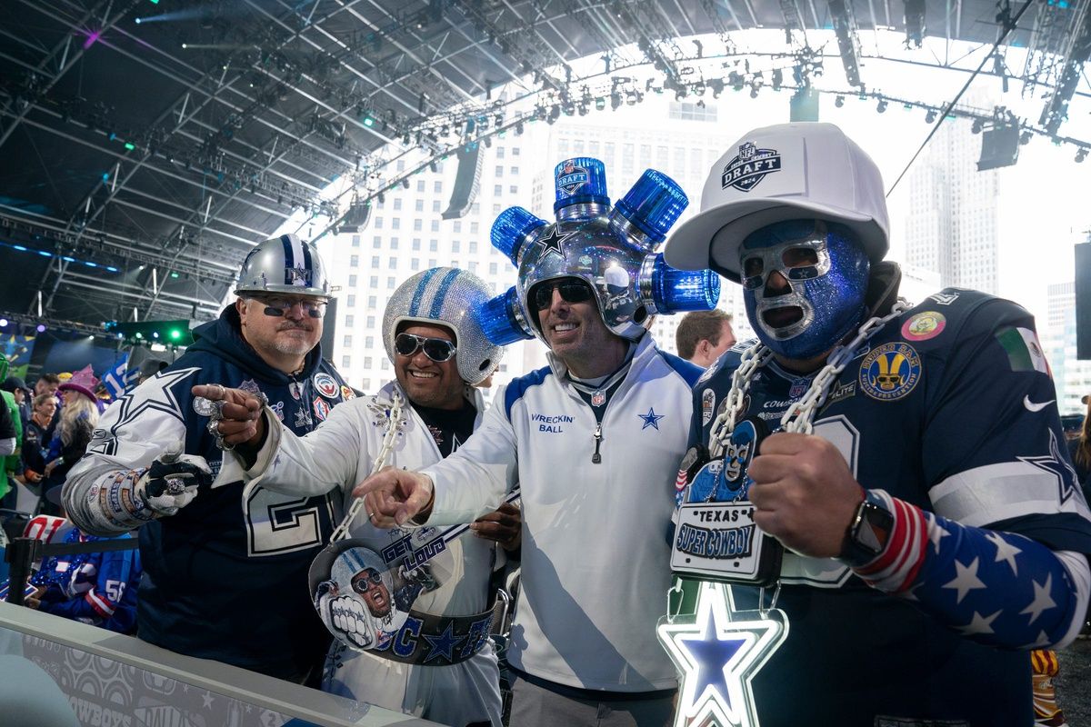 Dallas Cowboys fans pose for pictures at the 2024 NFL Draft.