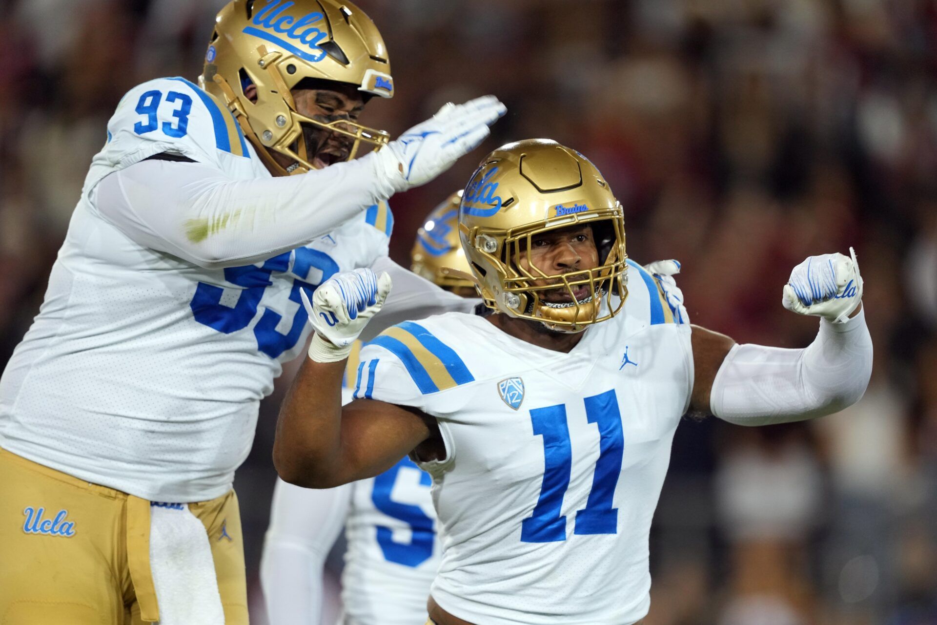 UCLA Bruins defensive lineman Gabriel Murphy (11) celebrates with defensive lineman Jay Toia (93) after recording a sack against the Stanford Cardinal during the first quarter at Stanford Stadium. Mandatory Credit: Darren Yamashita-USA TODAY Sports