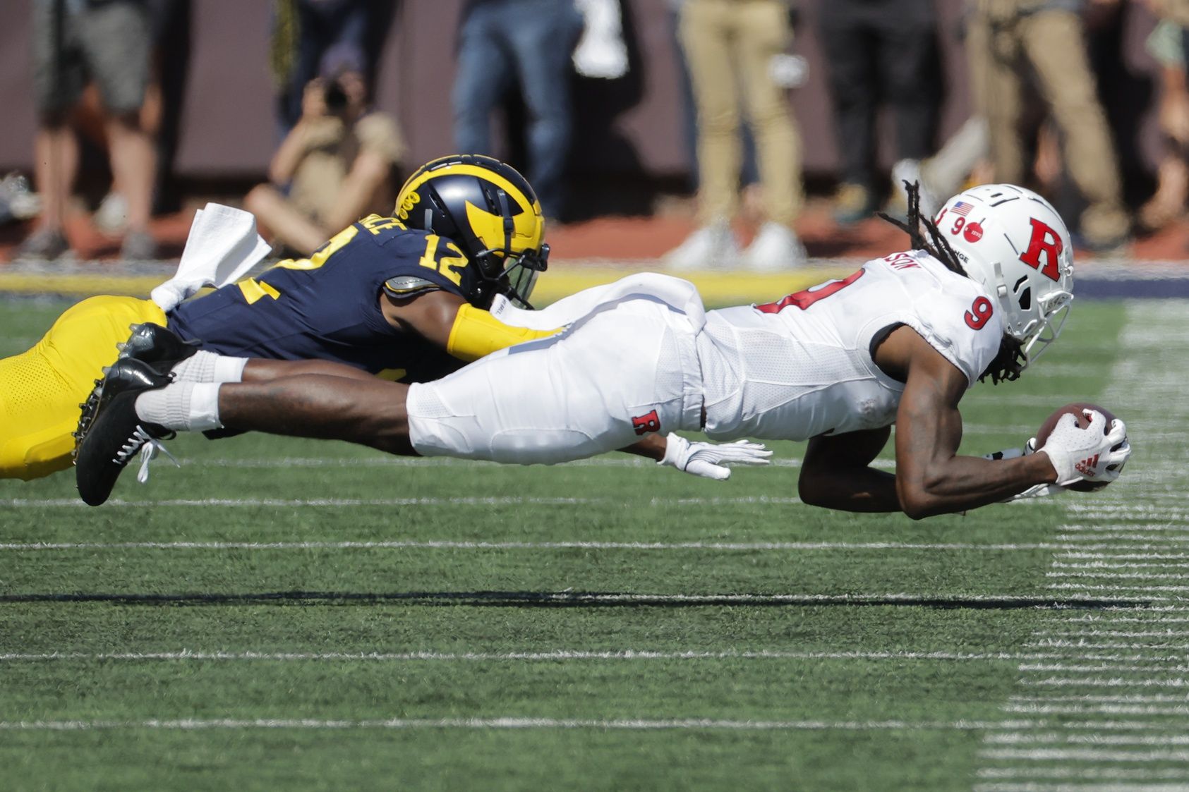 Rutgers Scarlet Knights wide receiver JaQuae Jackson (9) makes a reception against Michigan Wolverines defensive back Josh Wallace (12) in the second half at Michigan Stadium. Mandatory Credit: Rick Osentoski-USA TODAY Sports