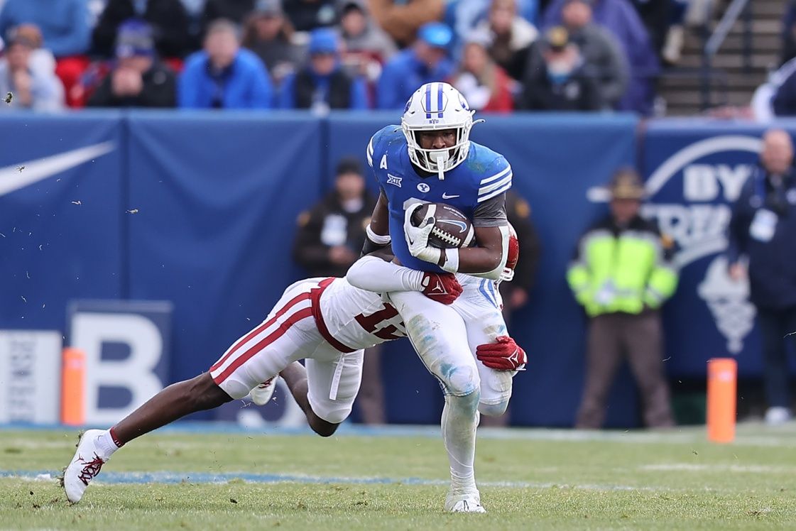 Brigham Young Cougars running back Aidan Robbins (3) is tackled by Oklahoma Sooners defensive back Key Lawrence (12) in the third quarter at LaVell Edwards Stadium.