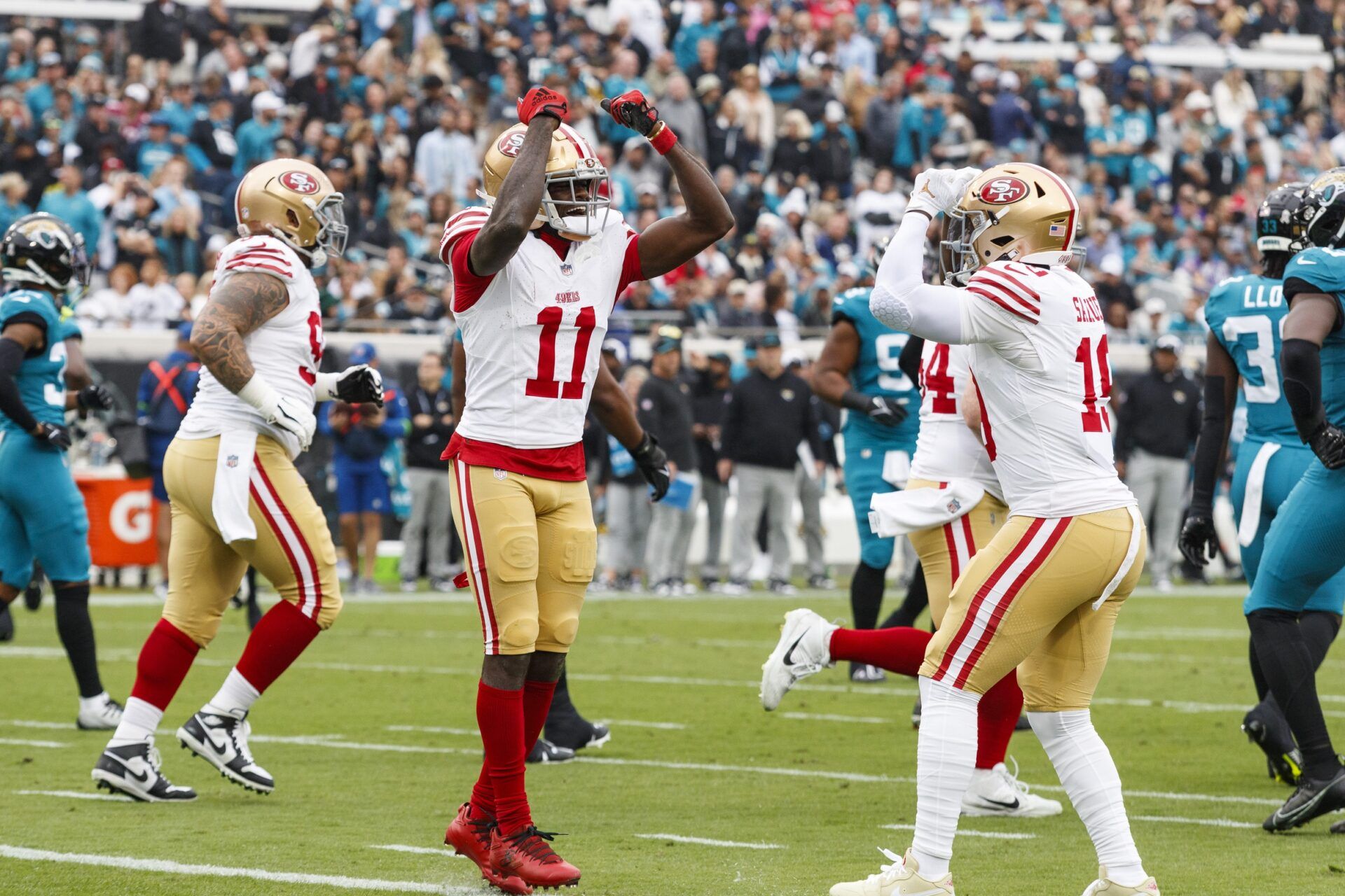 San Francisco 49ers wide receiver Brandon Aiyuk (11) and wide receiver Deebo Samuel (19) celebrate a touchdown against the Jacksonville Jaguars during the first quarter at EverBank Stadium.