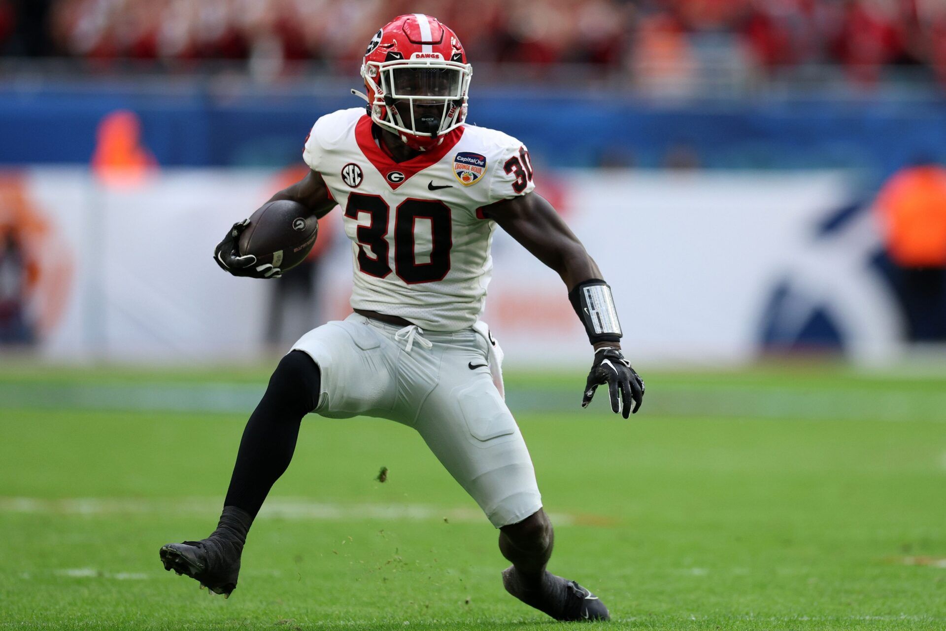 Georgia Bulldogs running back Daijun Edwards (30) rushes the ball against the Florida State Seminoles during the first half in the 2023 Orange Bowl at Hard Rock Stadium.