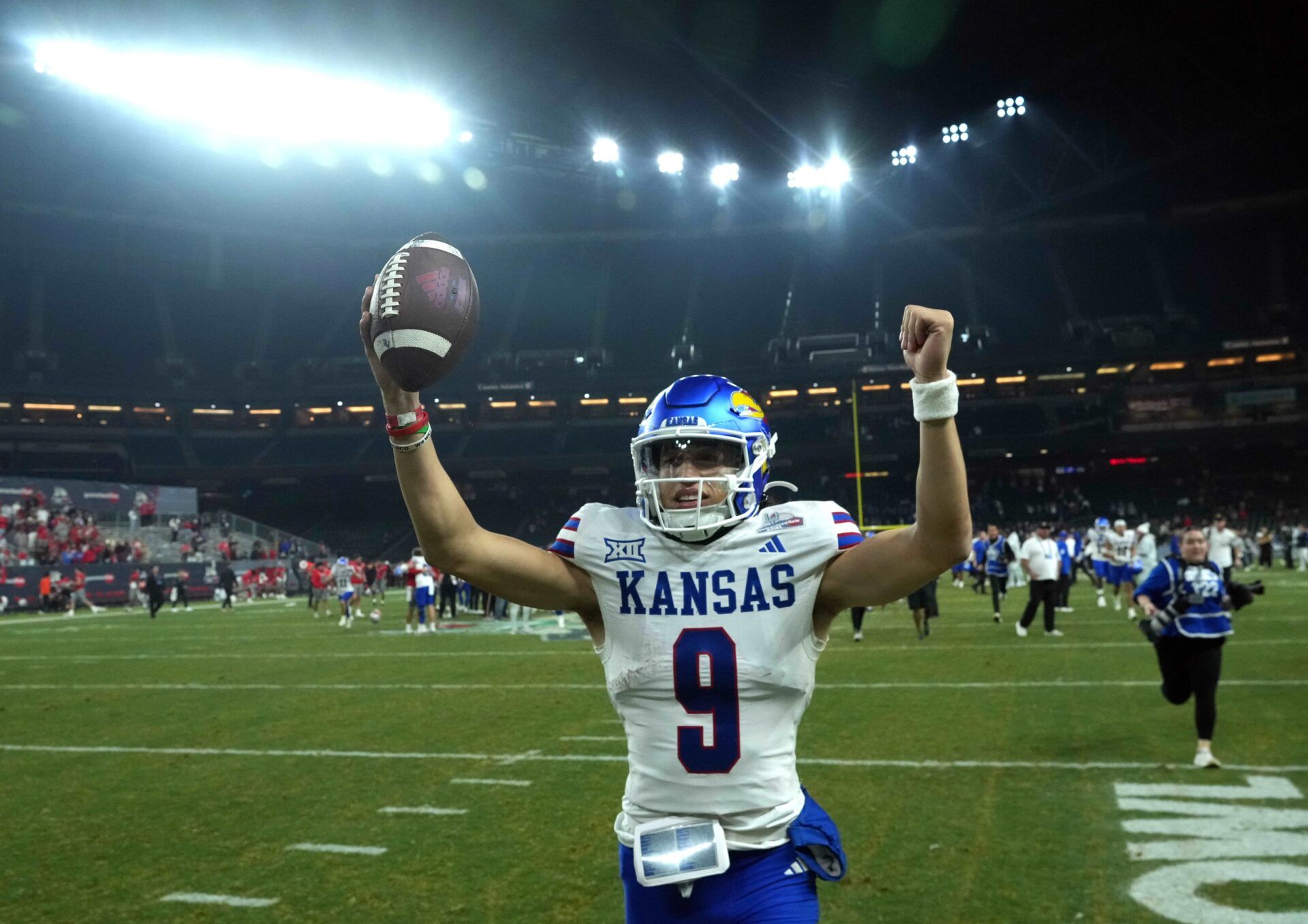 Kansas Jayhawks quarterback Jason Bean (9) celebrates after defeating the UNLV Rebels at Chase Field.