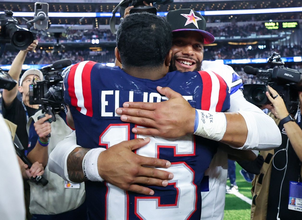 Dallas Cowboys quarterback Dak Prescott (4) hugs New England Patriots running back Ezekiel Elliott (15) after the game at AT&T Stadium.