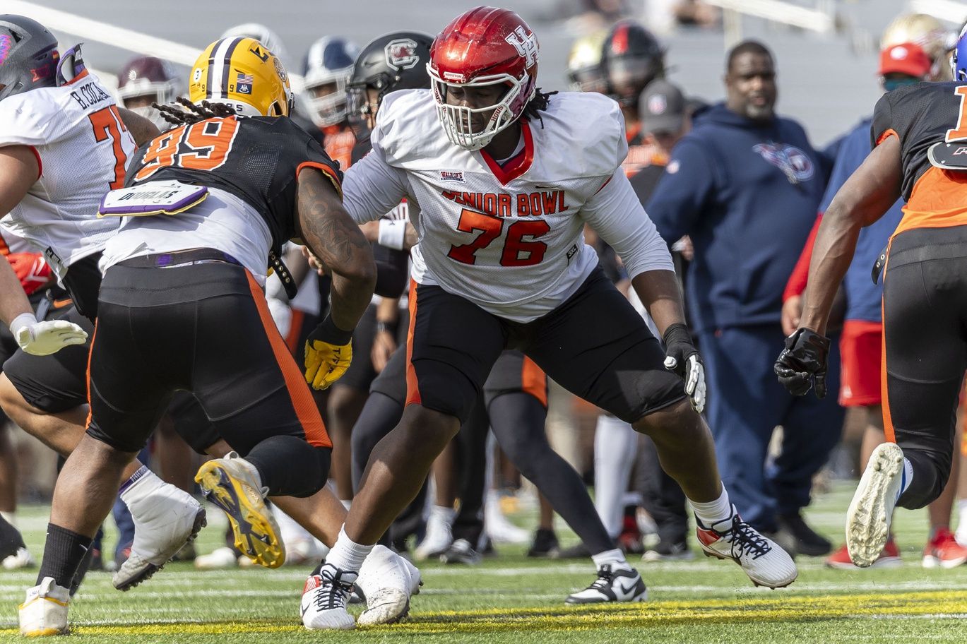 American offensive lineman Patrick Paul of Houston (76) faces off against American defensive lineman Jordan Jefferson of LSU (99) during practice for the American team at Hancock Whitney Stadium.