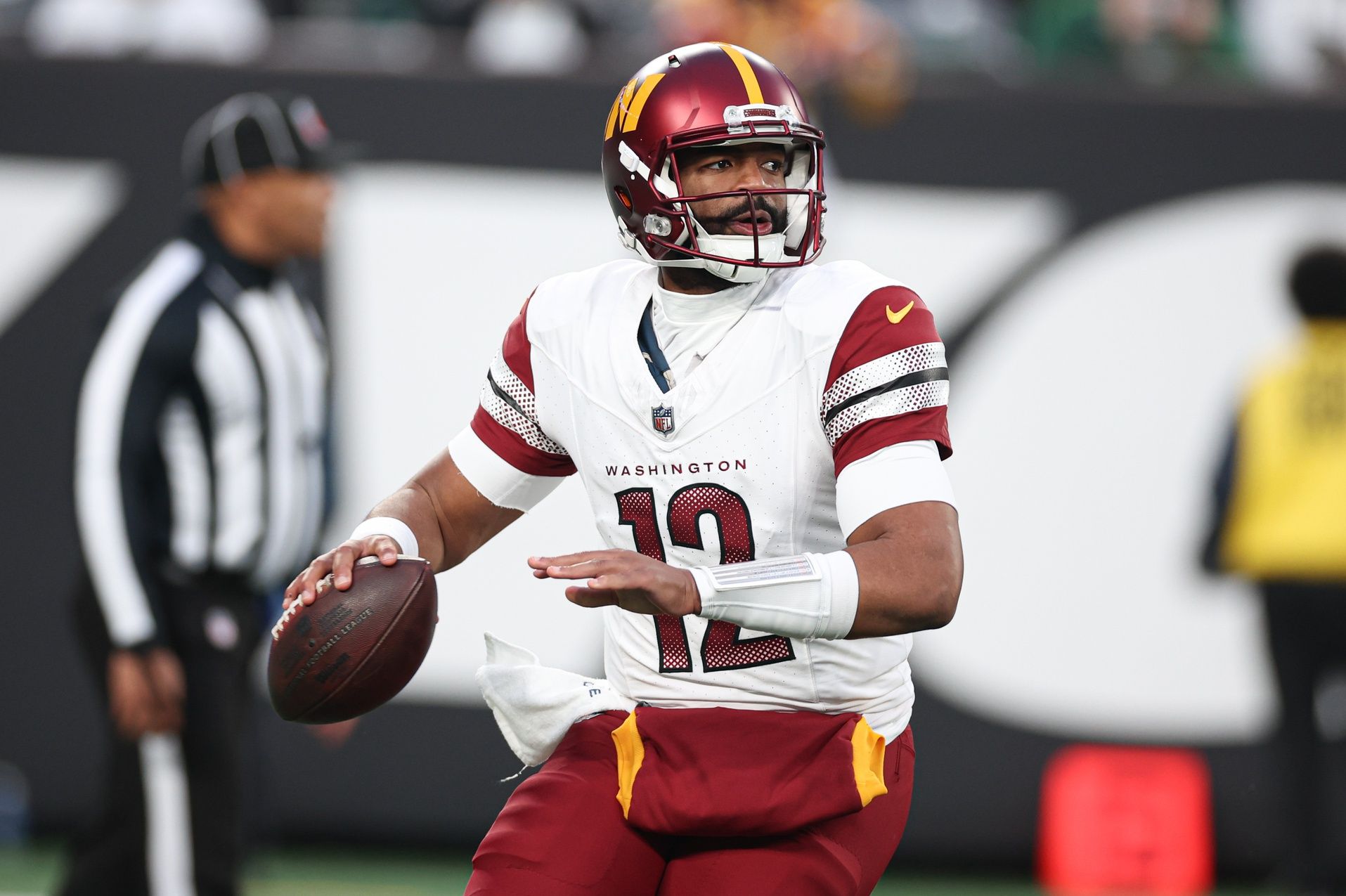 Washington Commanders QB Jacoby Brissett (12) looks to pass.