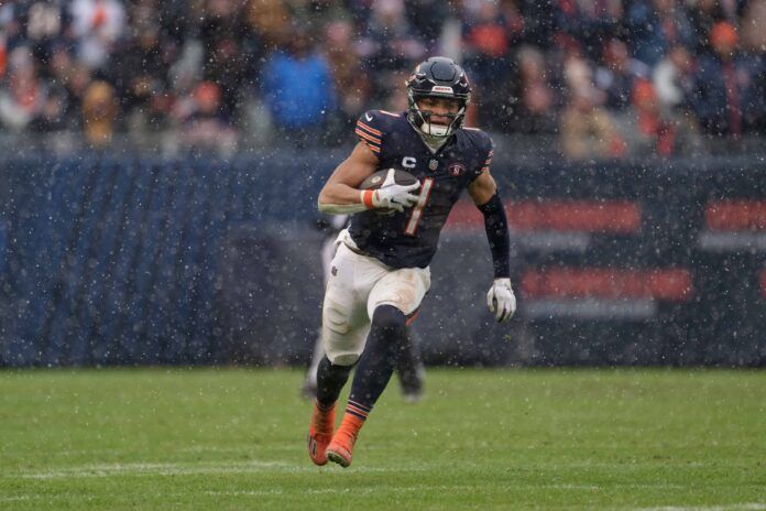 Chicago Bears quarterback Justin Fields (1) runs with the ball against the Atlanta Falcons at Soldier Field. Mandatory Credit: Jamie Sabau-USA TODAY Sports