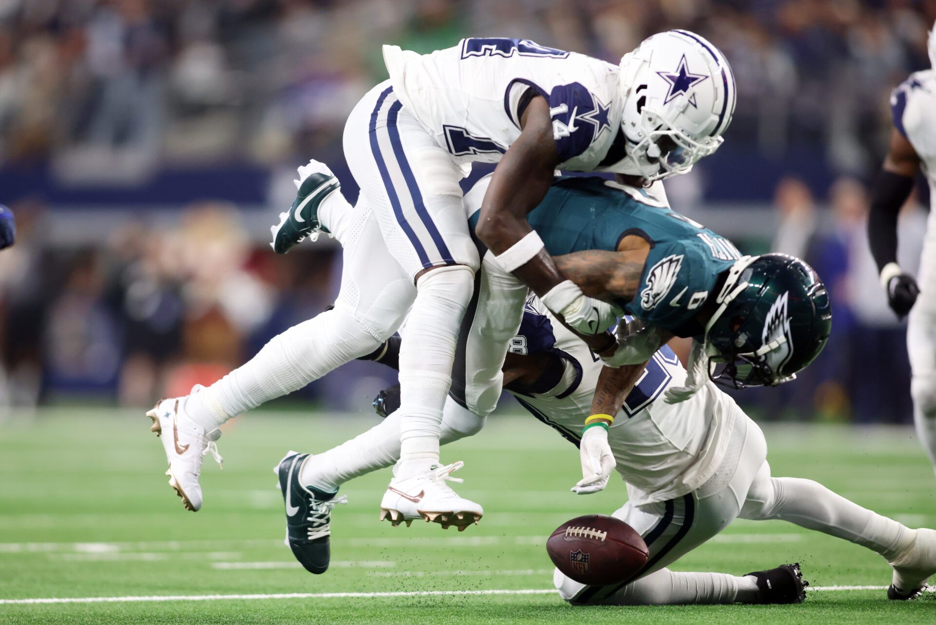 Philadelphia Eagles wide receiver DeVonta Smith (6) fumbles the ball after being hit by Dallas Cowboys safety Markquese Bell (14) in the fourth quarter at AT&T Stadium.