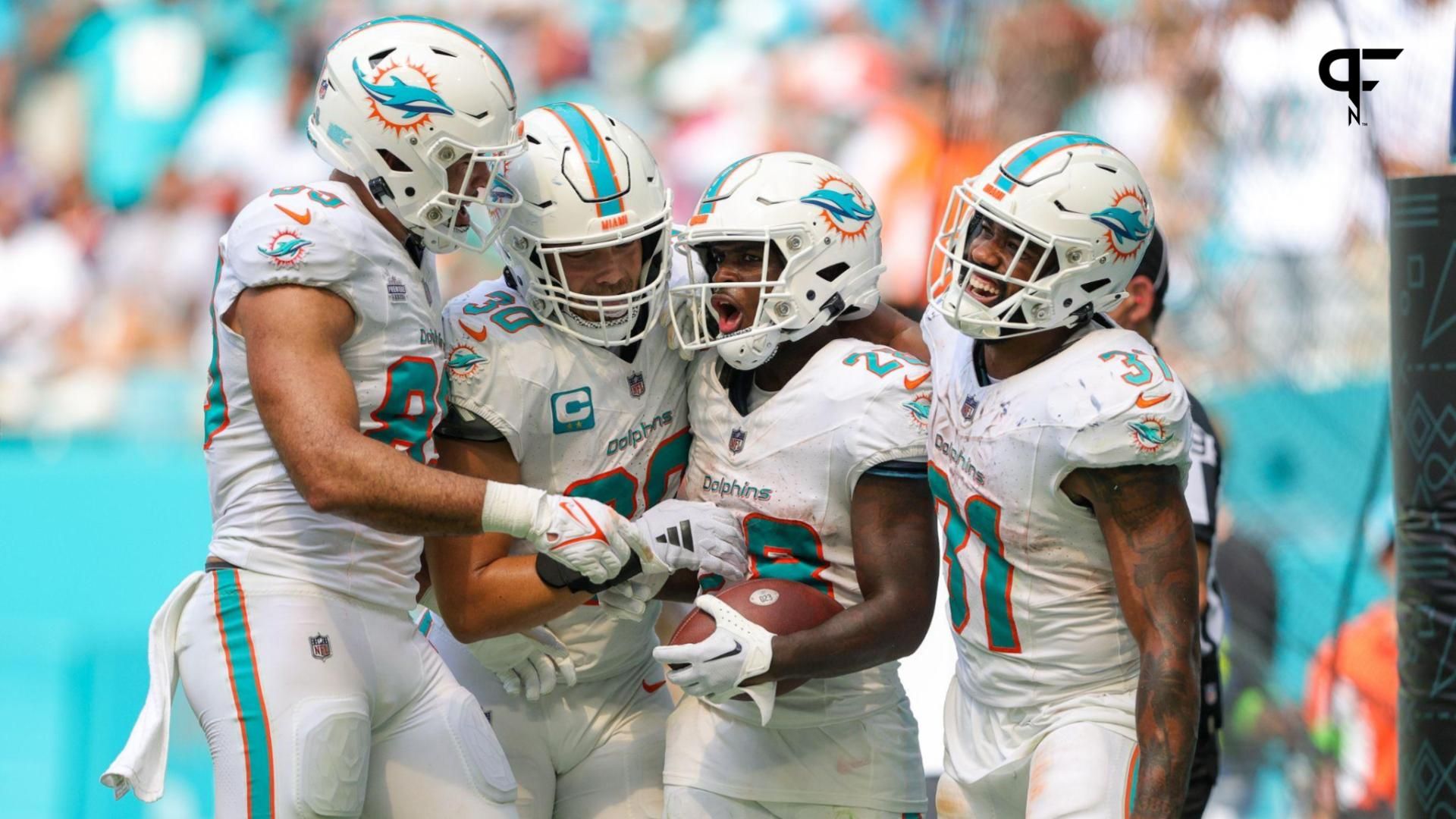 Miami Dolphins running back De'Von Achane (28) celebrates his touchdown with Miami Dolphins running back Raheem Mostert (31) against the Denver Broncos in the fourth quarter at Hard Rock Stadium.