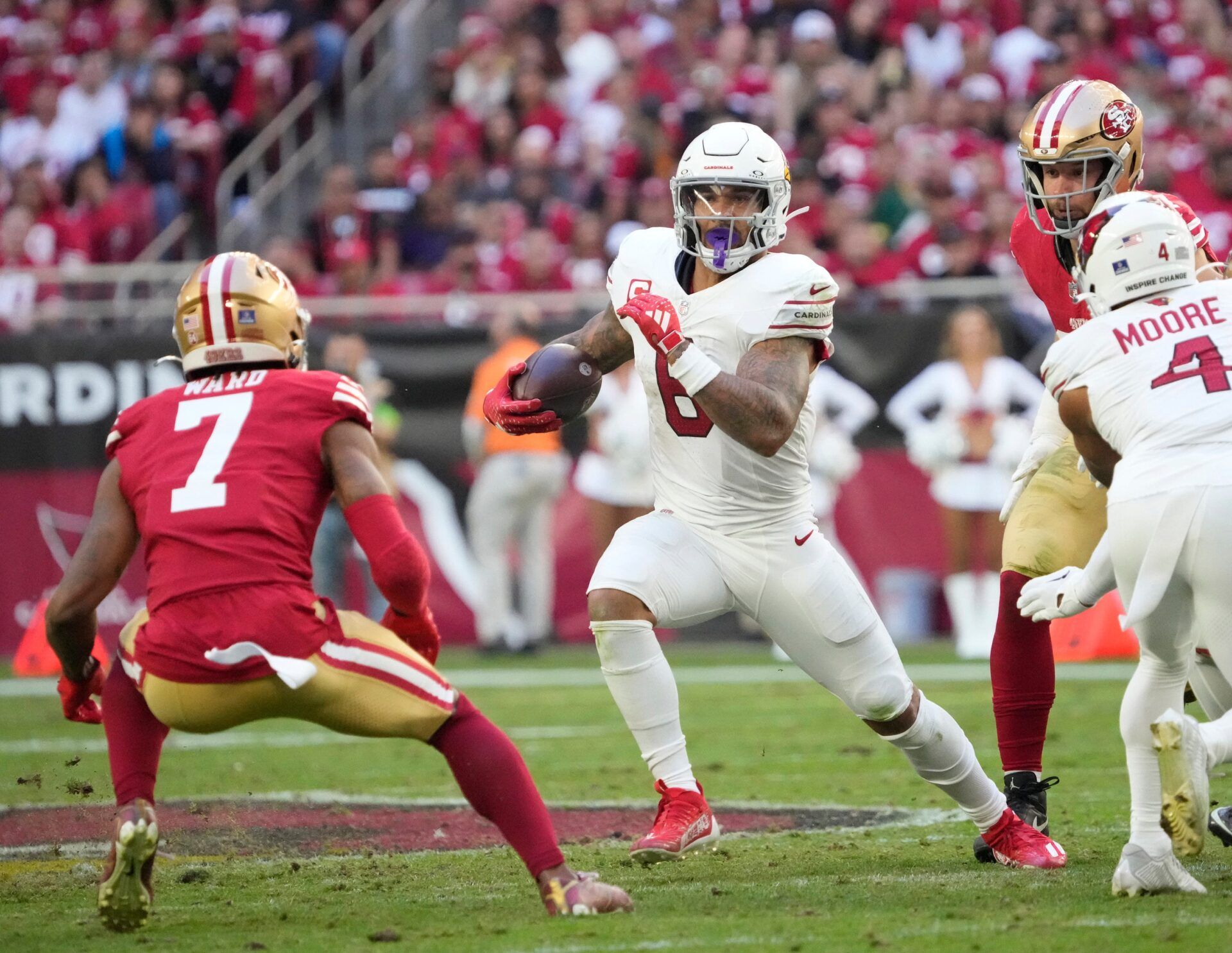 Arizona Cardinals running back James Conner (6) looks to get around San Francisco 49ers cornerback Charvarius Ward (7) during the second quarter at State Farm Stadium.