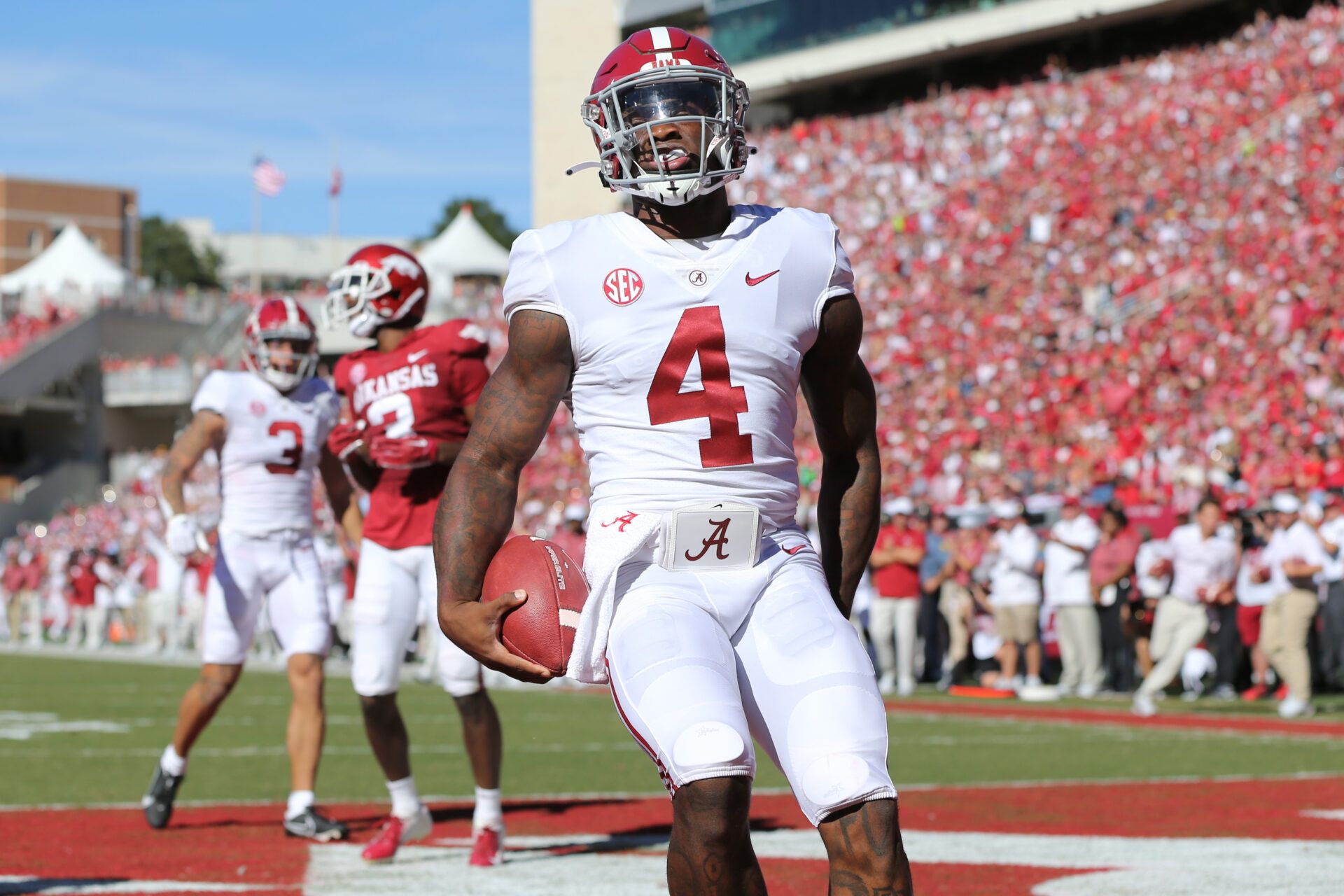 Alabama Crimson Tide quarterback Jalen Milroe (4) rushes for a touchdown in the second quarter against the Arkansas Razorbacks at Donald W. Reynolds Razorback Stadium.