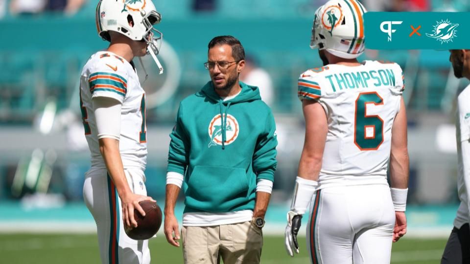 Miami Dolphins head coach Mike McDaniel talks with quarterbacks Skylar Thompson (6) and Mike White (14).