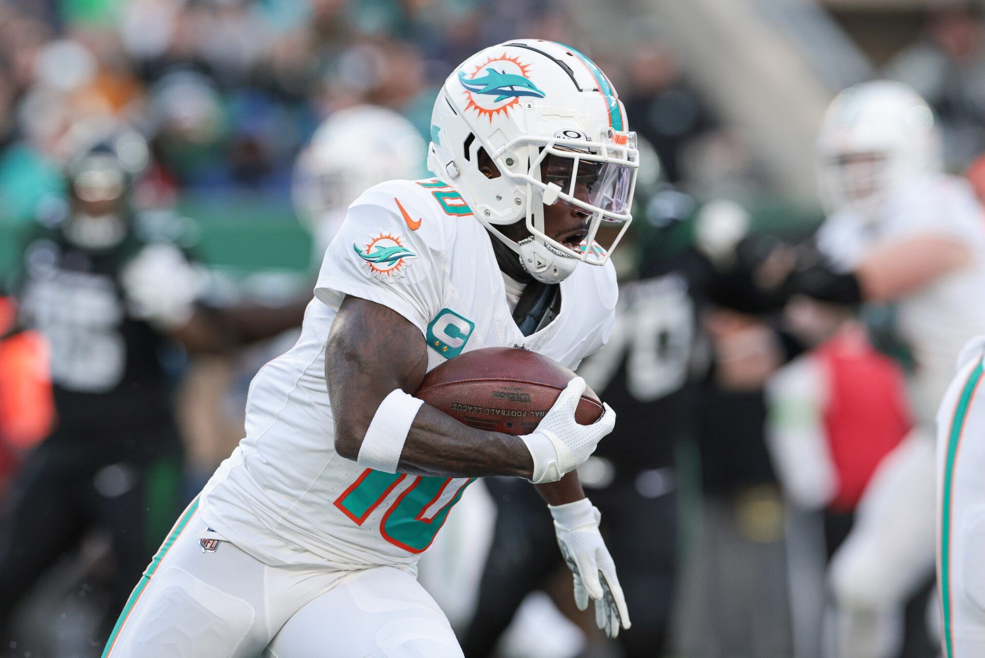 Miami Dolphins wide receiver Tyreek Hill (10) carries the ball during the first half against the New York Jets at MetLife Stadium. Mandatory Credit: Vincent Carchietta-USA TODAY Sports