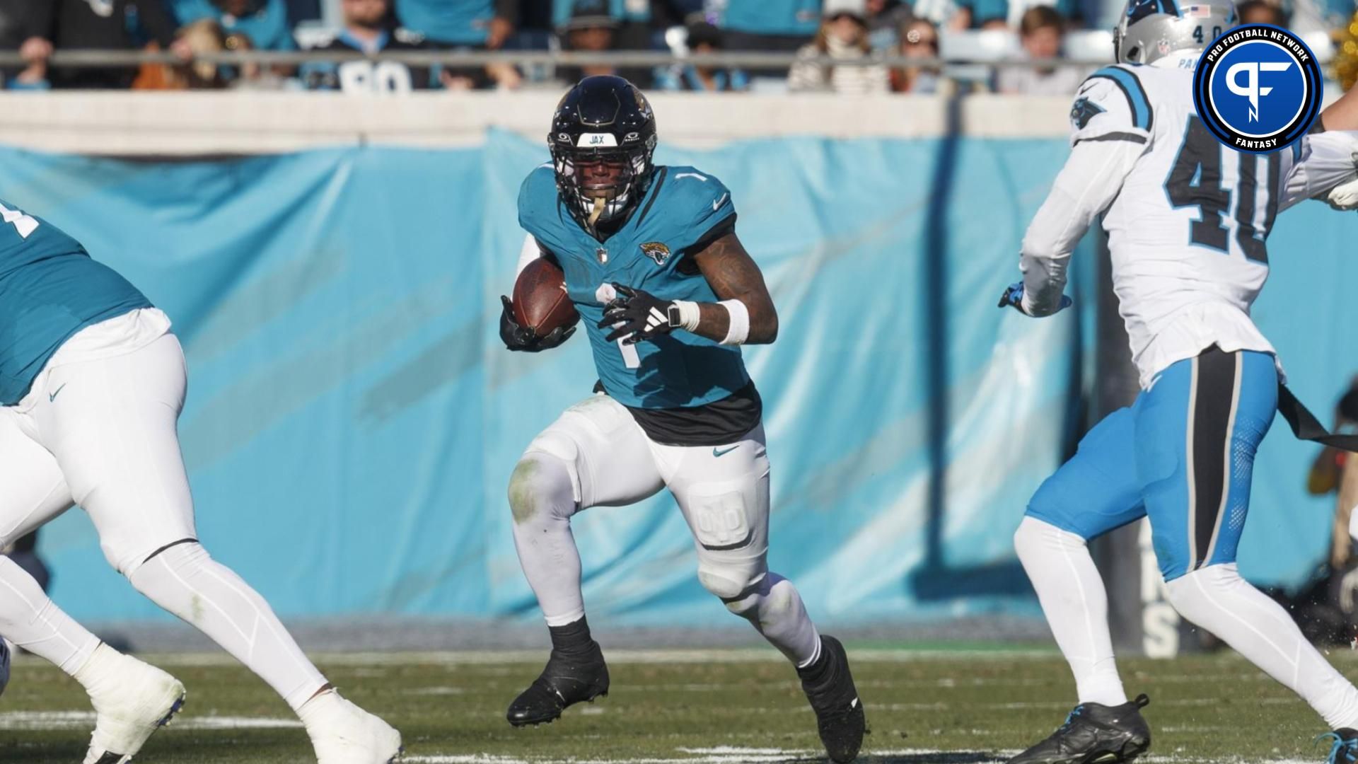 Jacksonville Jaguars running back Travis Etienne Jr. (1) runs the ball against the Carolina Panthers during the fourth quarter at EverBank Stadium.