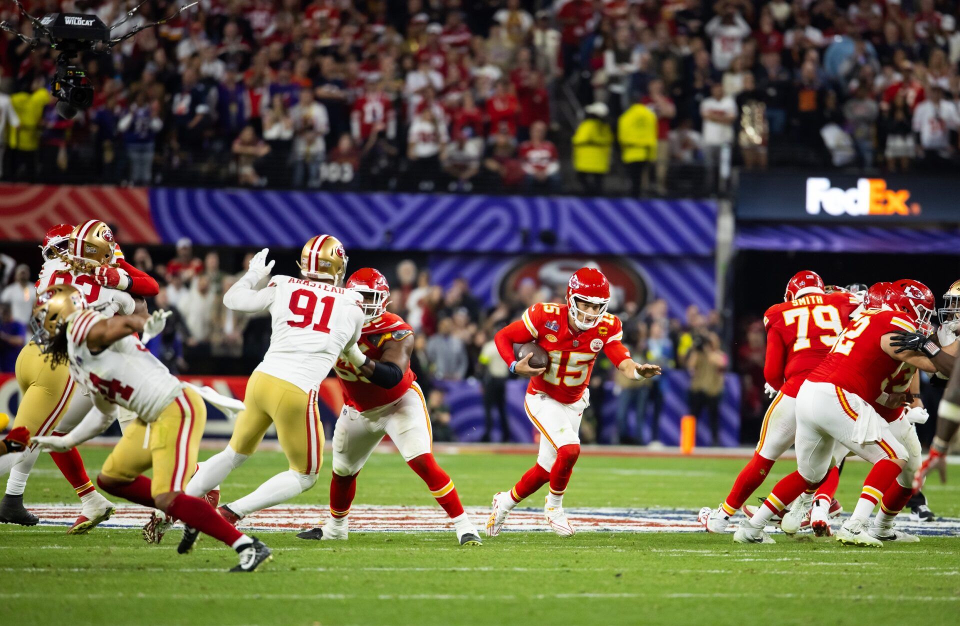 Kansas City Chiefs quarterback Patrick Mahomes (15) runs the ball against the San Francisco 49ers during Super Bowl LVIII at Allegiant Stadium.