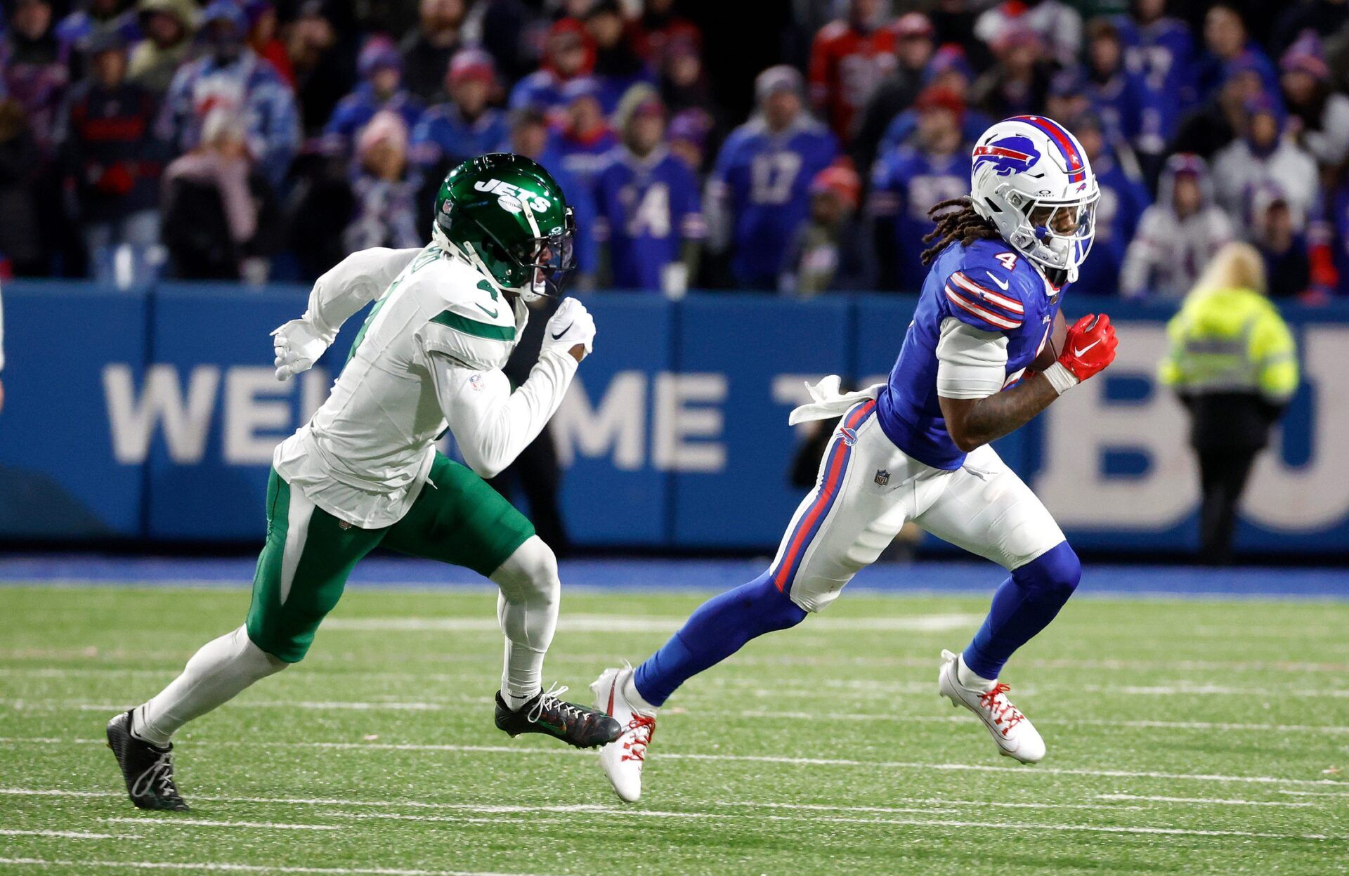 Buffalo Bills RB James Cook (4) attempts to run away from New York Jets CB D.J. Reed (4).