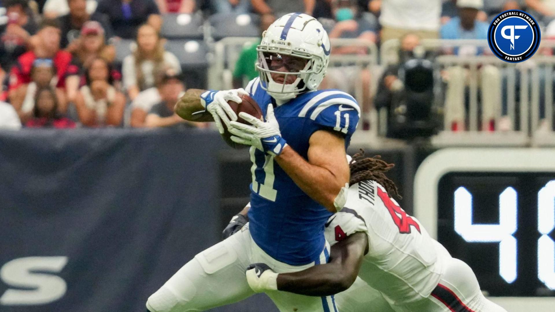 Houston Texans cornerback Tavierre Thomas (4) works to bring down Indianapolis Colts wide receiver Michael Pittman Jr. (11) on Sunday, Sept. 17, 2023, during a game against the Houston Texans at NRG Stadium in Houston.