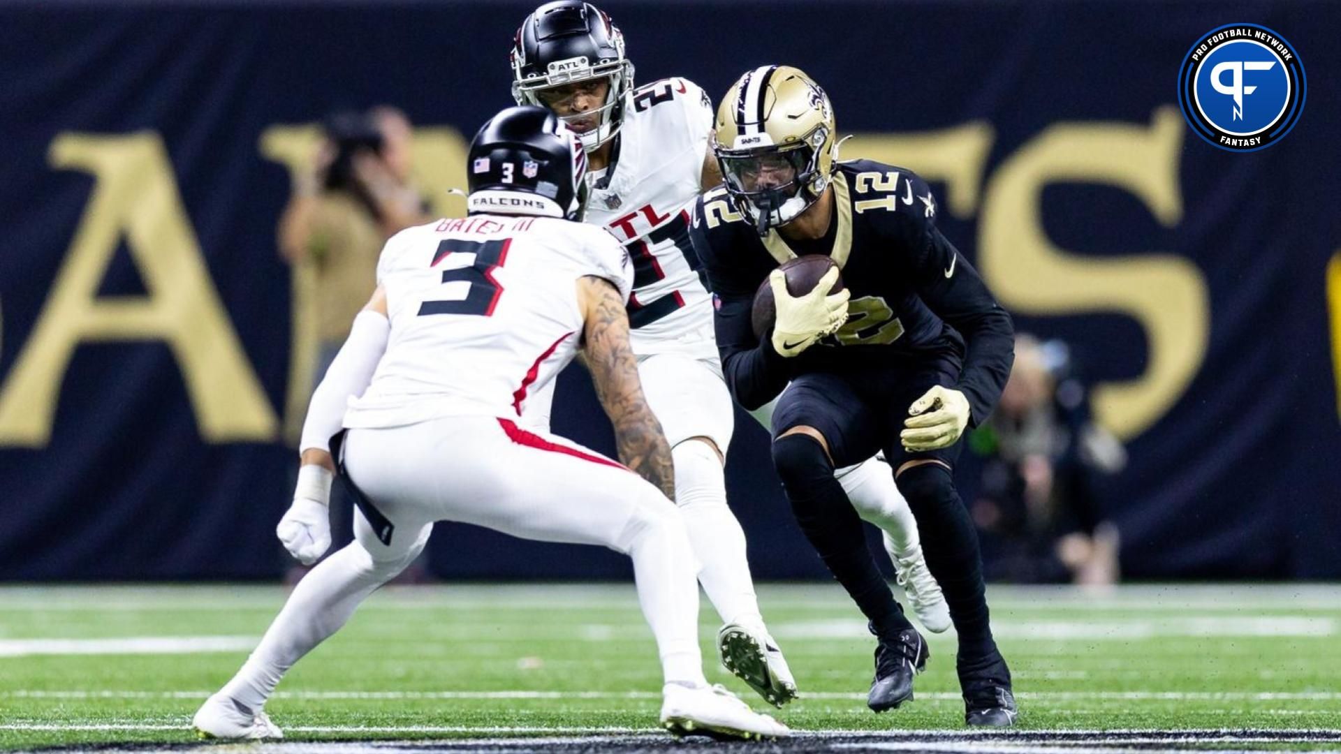 New Orleans Saints wide receiver Chris Olave (12) is tackled by Atlanta Falcons safety Jessie Bates III (3) during the first half at Caesars Superdome.