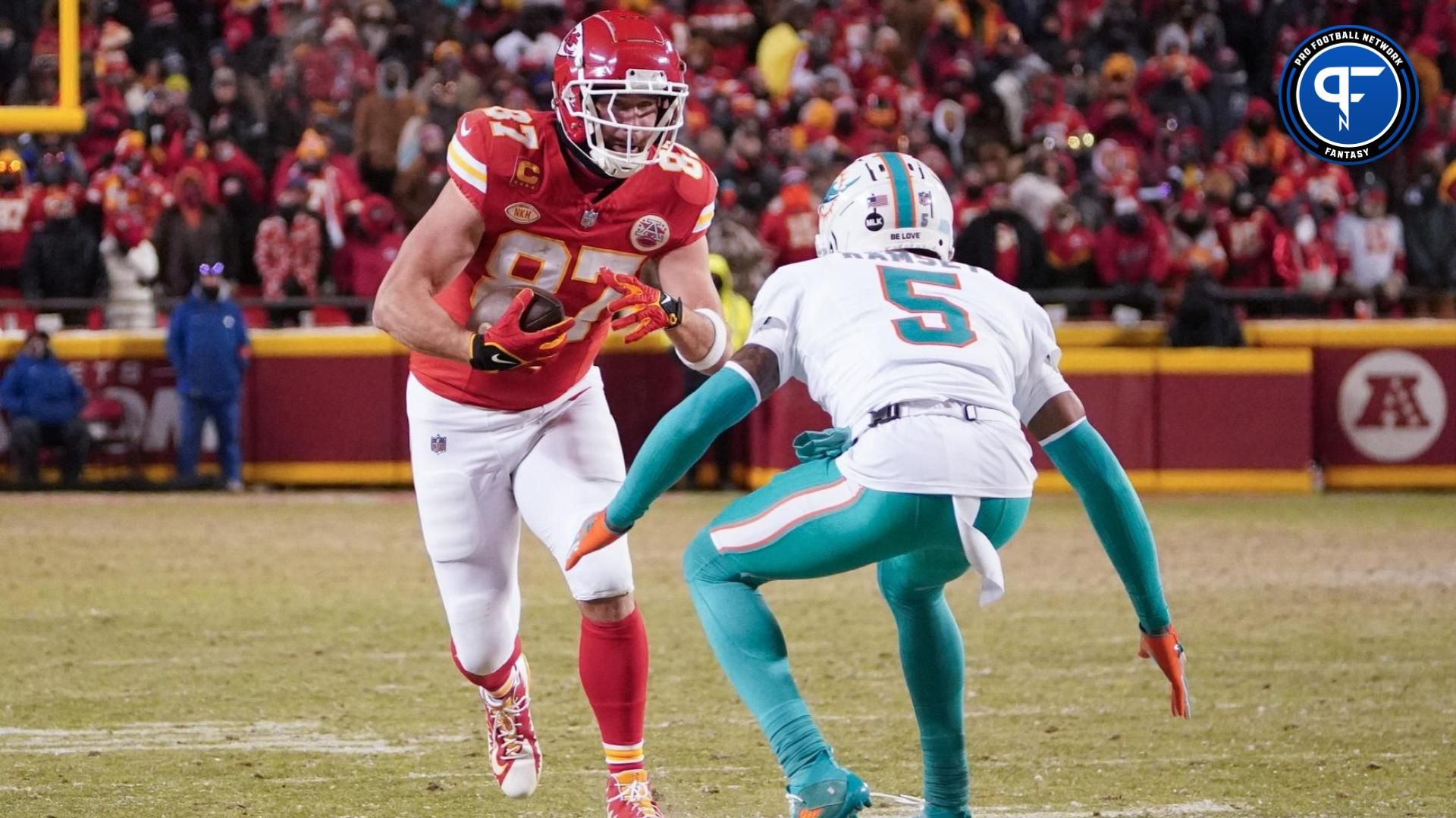 Kansas City Chiefs tight end Travis Kelce (87) runs the ball against Miami Dolphins cornerback Jalen Ramsey (5) during the second half of the 2024 AFC wild card game at GEHA Field at Arrowhead Stadium.