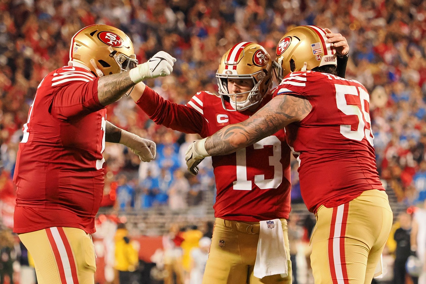 Jan 28, 2024; Santa Clara, California, USA; San Francisco 49ers quarterback Brock Purdy (13) celebrates with guard Jon Feliciano (55) and offensive tackle Trent Williams (71) after a play against the Detroit Lions during the second half of the NFC Championship football game at Levi's Stadium. Mandatory Credit: Kelley L Cox-USA TODAY Sports