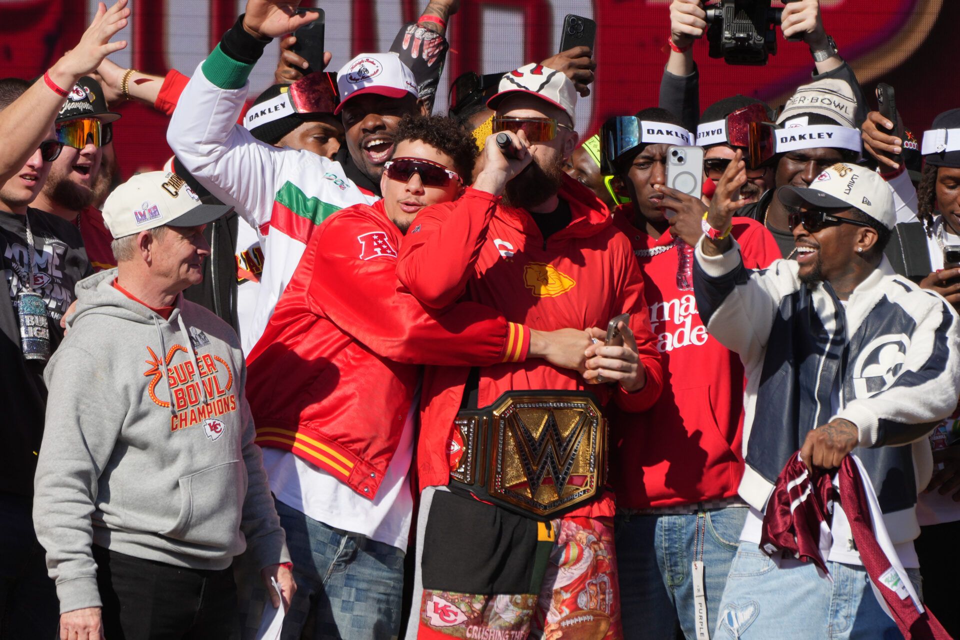 Kansas City Chiefs quarterback Patrick Mahomes (15) embraces tight end Travis Kelce (87) on stage during the celebration of the Kansas City Chiefs winning Super Bowl LVIII.