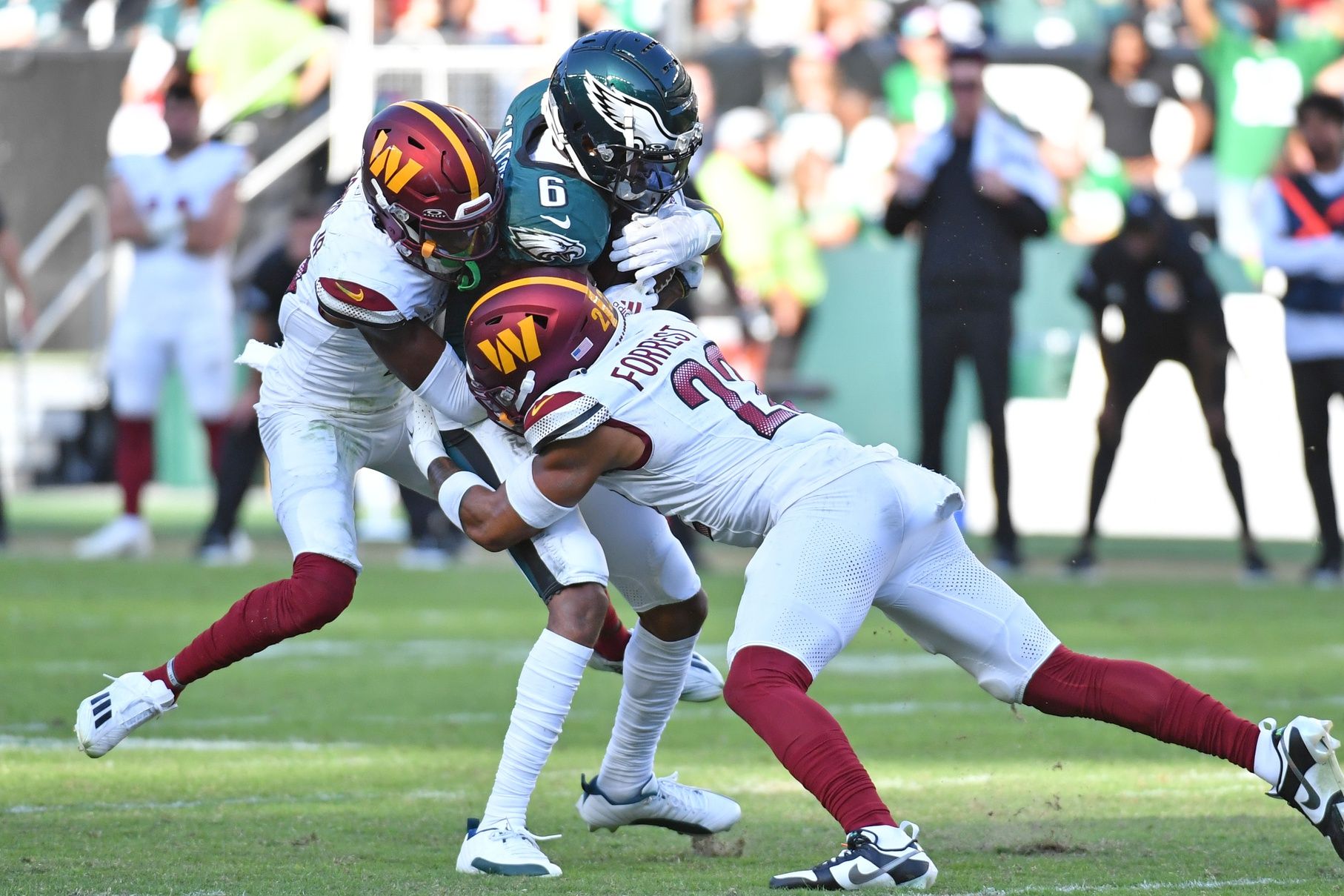 Philadelphia Eagles wide receiver DeVonta Smith (6) is tackled by Washington Commanders cornerback Emmanuel Forbes (13) and safety Darrick Forrest (22) in overtime at Lincoln Financial Field. Mandatory Credit: Eric Hartline-USA TODAY Sports