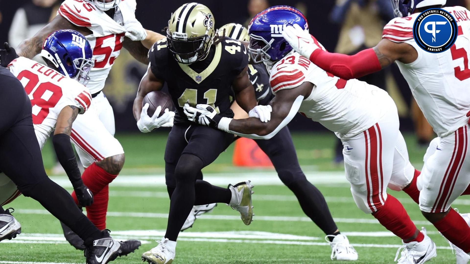 New Orleans Saints running back Alvin Kamara (41) runs the ball while defended by New York Giants defensive tackle Rakeem Nunez-Roches (93) during the first half at Caesars Superdome.