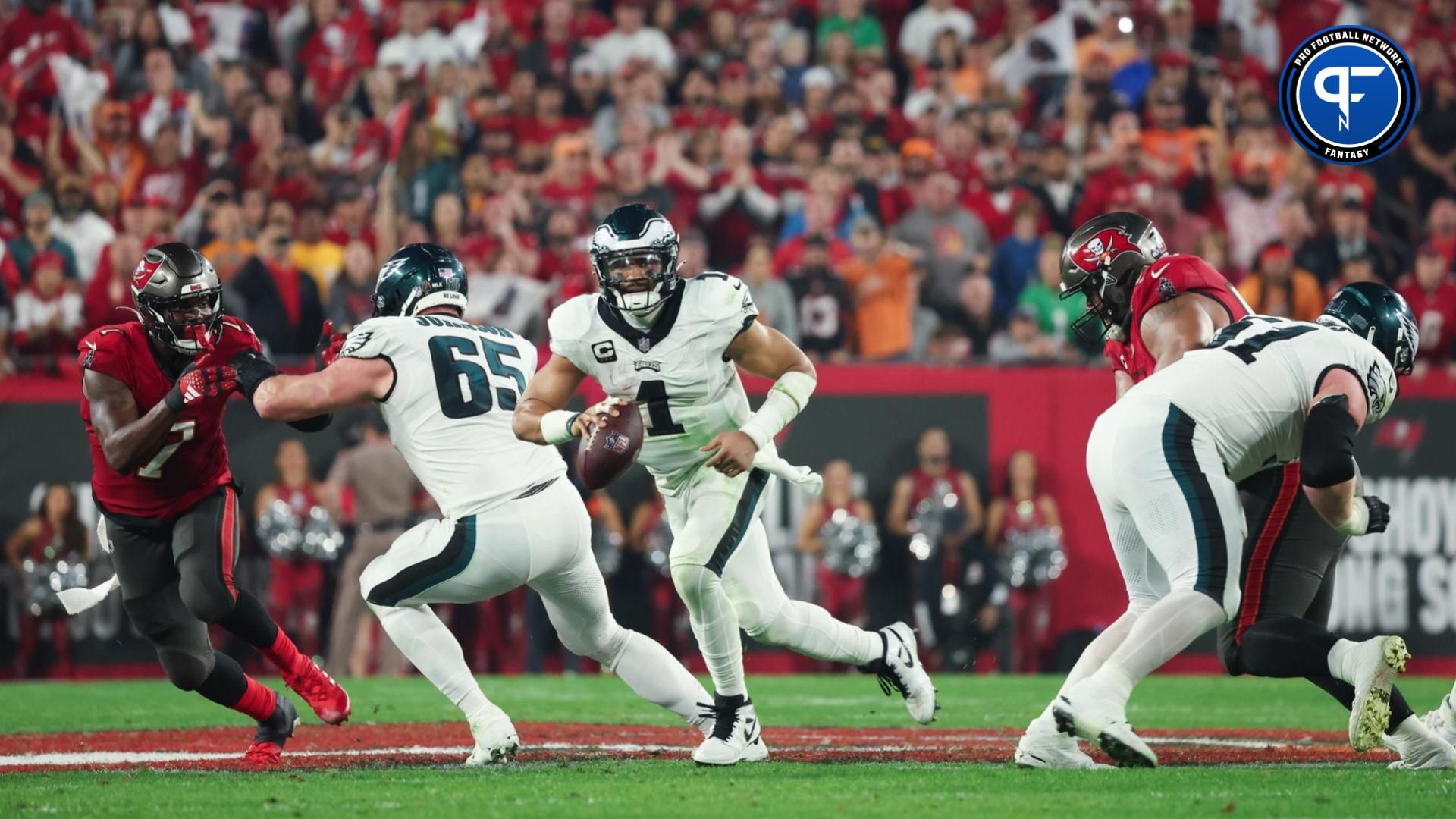 Philadelphia Eagles quarterback Jalen Hurts (1) runs with the ball against the Tampa Bay Buccaneers during the second half of a 2024 NFC wild card game at Raymond James Stadium.