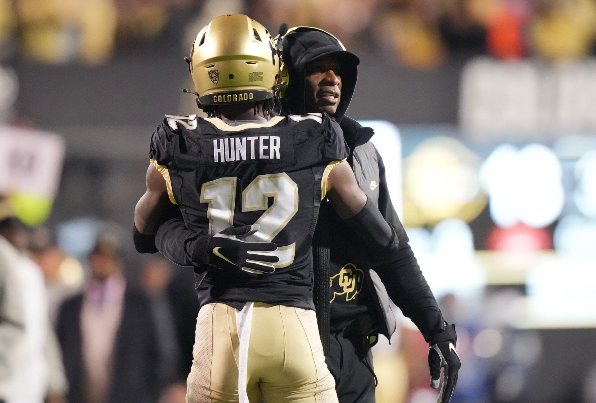 Colorado Buffaloes wide receiver Travis Hunter (12) is congratulated for his touchdown by head coach Deion Sanders in the first quarter against the Stanford Cardinal at Folsom Field. Mandatory Credit: Ron Chenoy-USA TODAY Sports