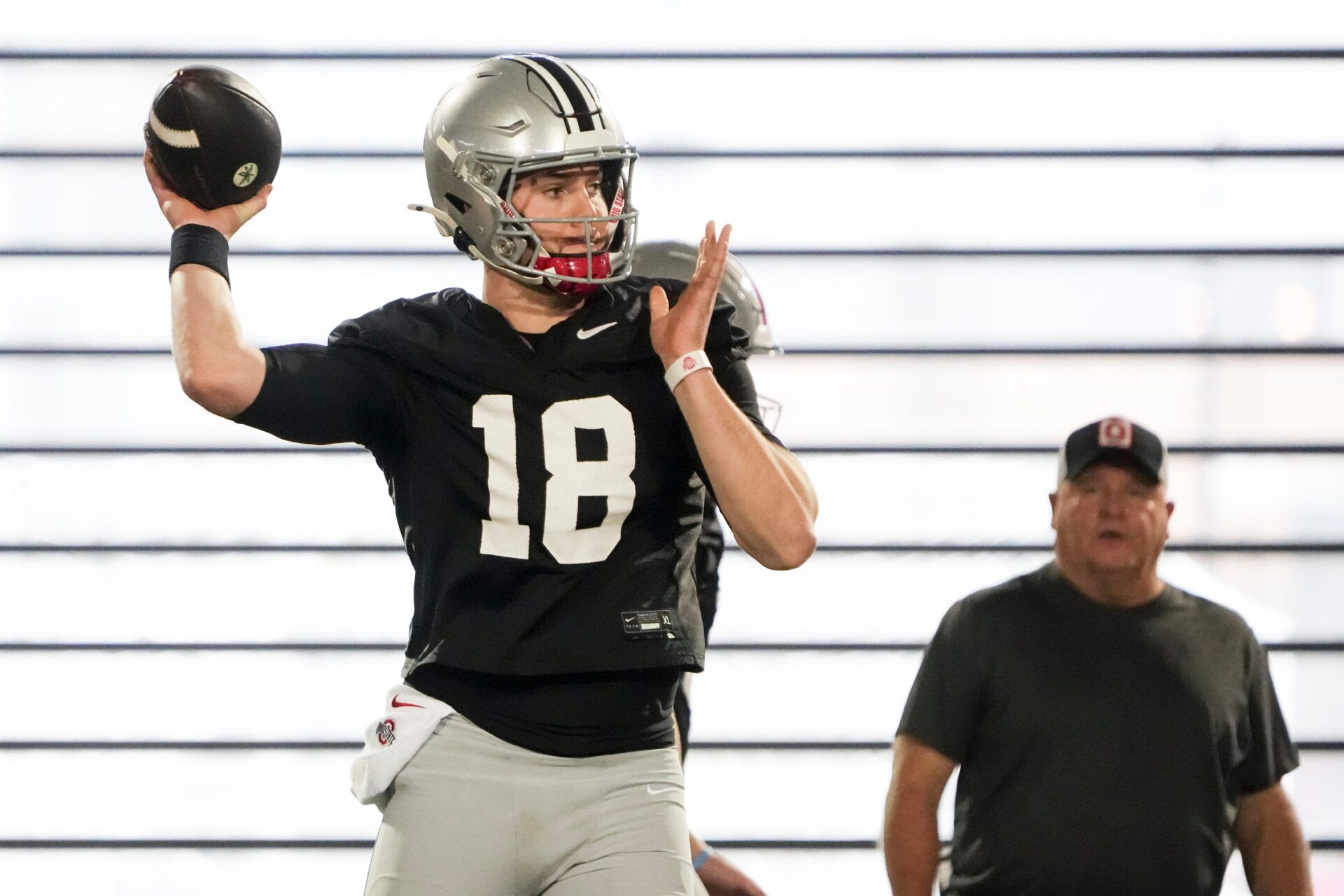 Ohio State Buckeyes offensive coordinator Chip Kelly watches quarterback Will Howard (18) throw during spring football practice at the Woody Hayes Athletic Center.