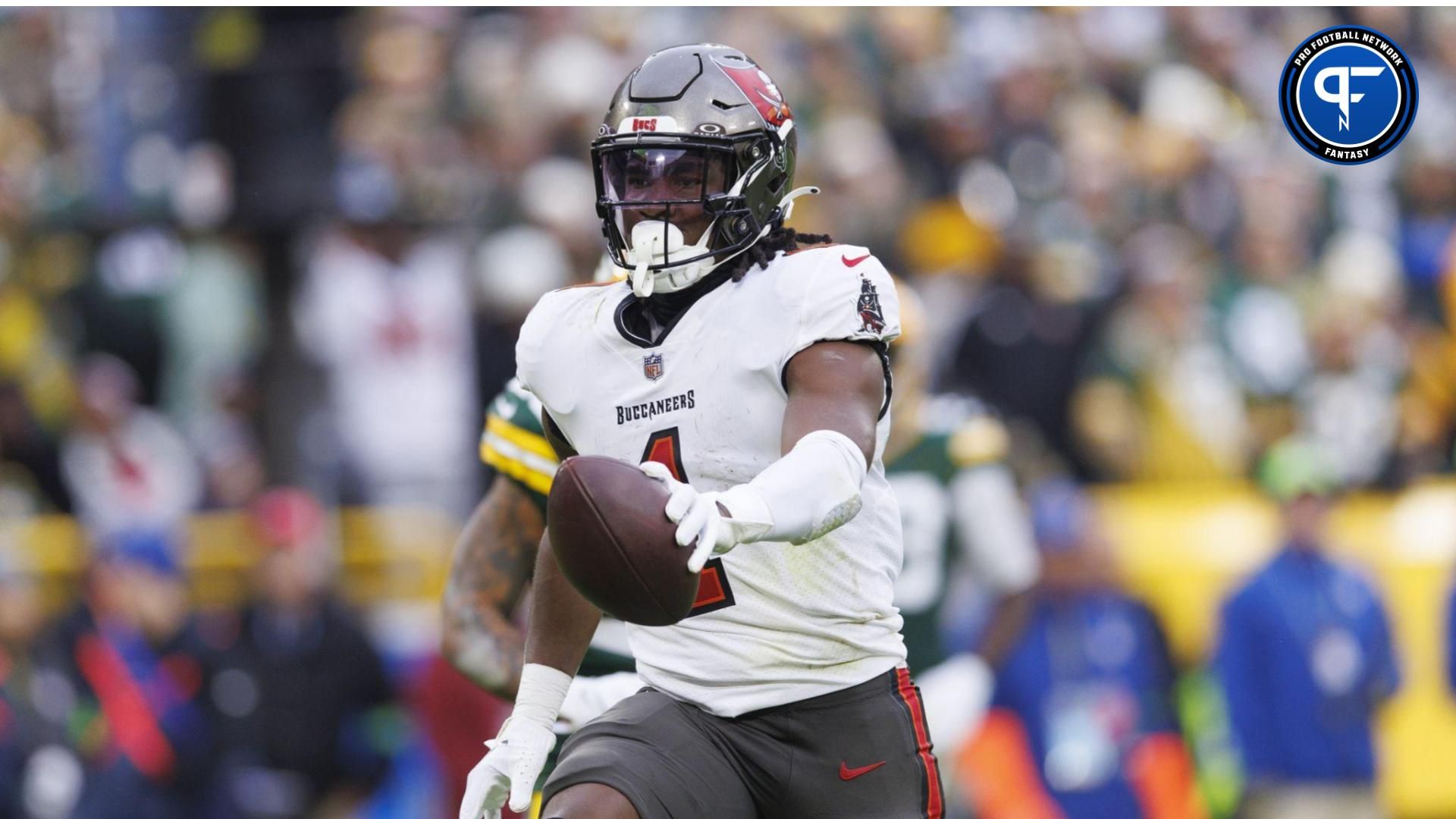 Tampa Bay Buccaneers running back Rachaad White (1) holds the ball out while scoring a touchdown during the third quarter against the Green Bay Packers at Lambeau Field. Mandatory Credit: Jeff Hanisch-USA TODAY Sports