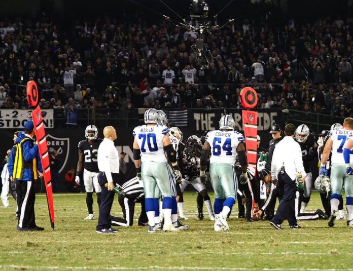 The referees measure to determine Dallas Cowboys reached first down against the Oakland Raiders during the fourth quarter at Oakland Coliseum.