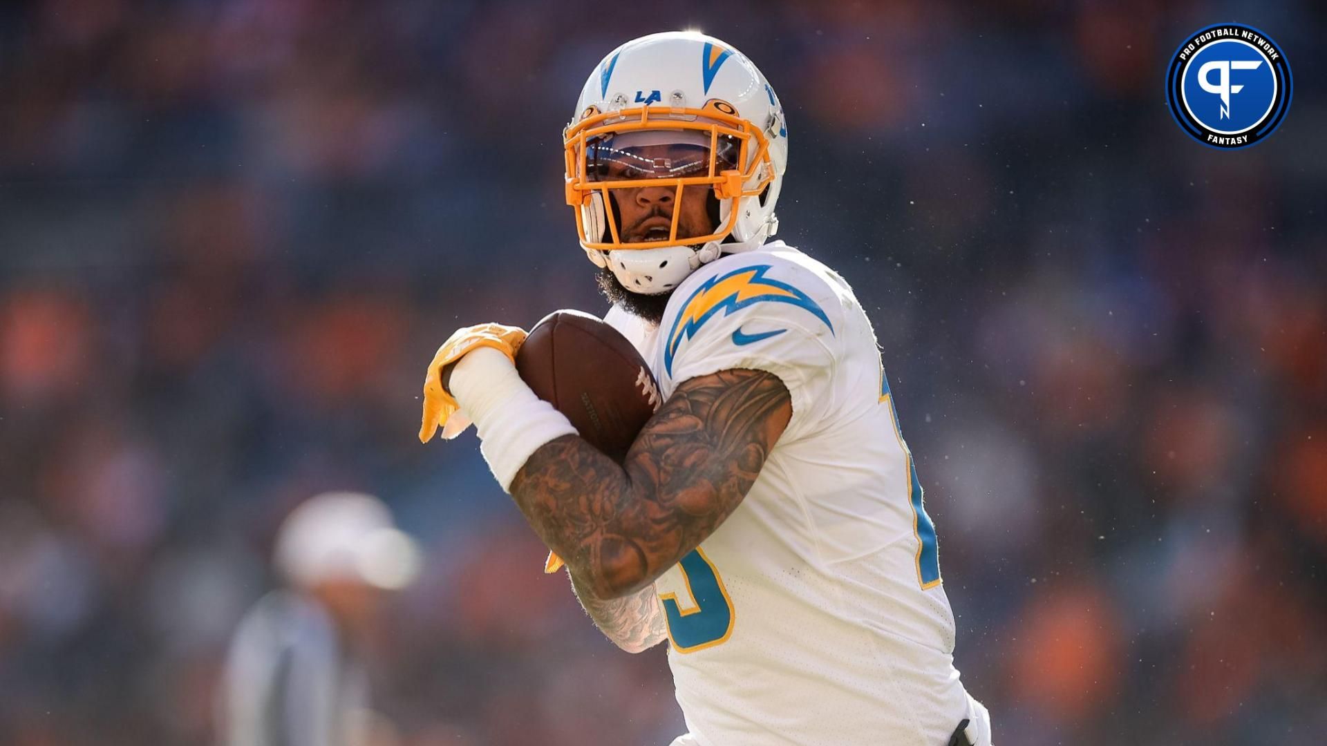 Los Angeles Chargers wide receiver Keenan Allen (13) catches the ball and runs for a touchdown in the first quarter against the Denver Broncos at Empower Field at Mile High.